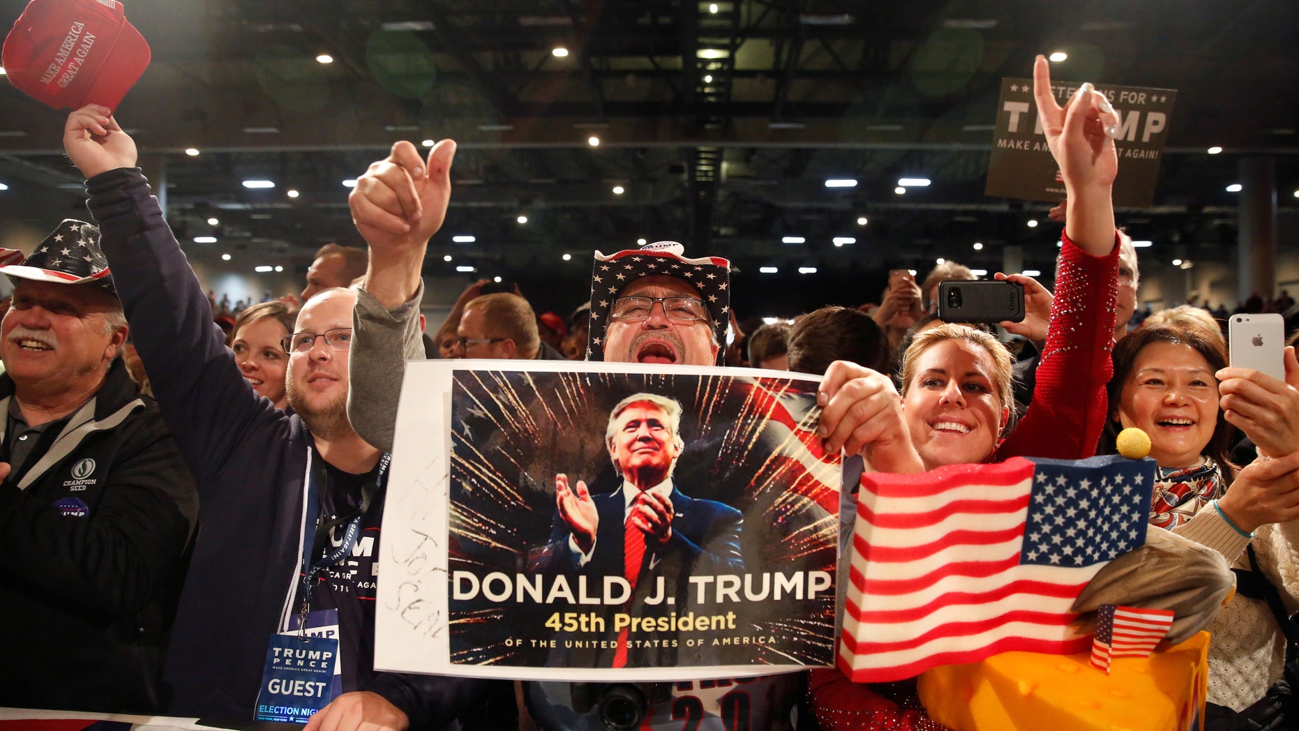 Supporters of U.S. President-elect Donald Trump cheer at the USA Thank You Tour event at the Iowa Events Center in Des Moines, Iowa, U.S., December 8, 2016. REUTERS/Shannon Stapleton - RTSVBN0