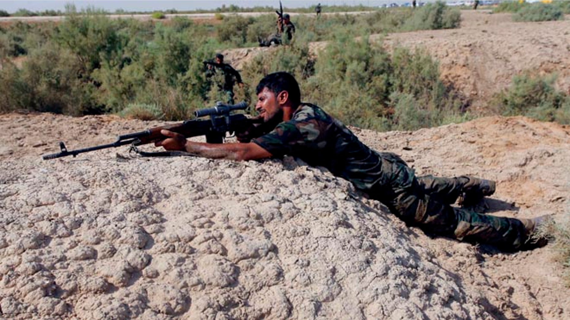 FILE: August 23, 2014: A Shite fighter, who has joined in the fight against Islamic State, taking part in field training in Najaf, Iraq.