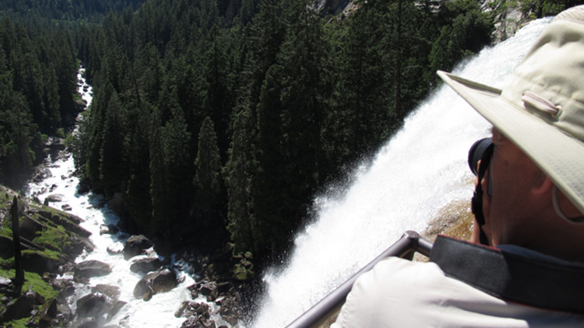 July 20, 2011: A hiker takes a photo from the top of Vernal Falls in Yosemite. Yosemite National Park officials say one boy is dead and another is missing after they were swept away Aug. 15, 2012 in the Merced River. Park officials say the two were part of a family visiting from Southern California that had been hiking near the Vernal Fall Footbridge. (AP)