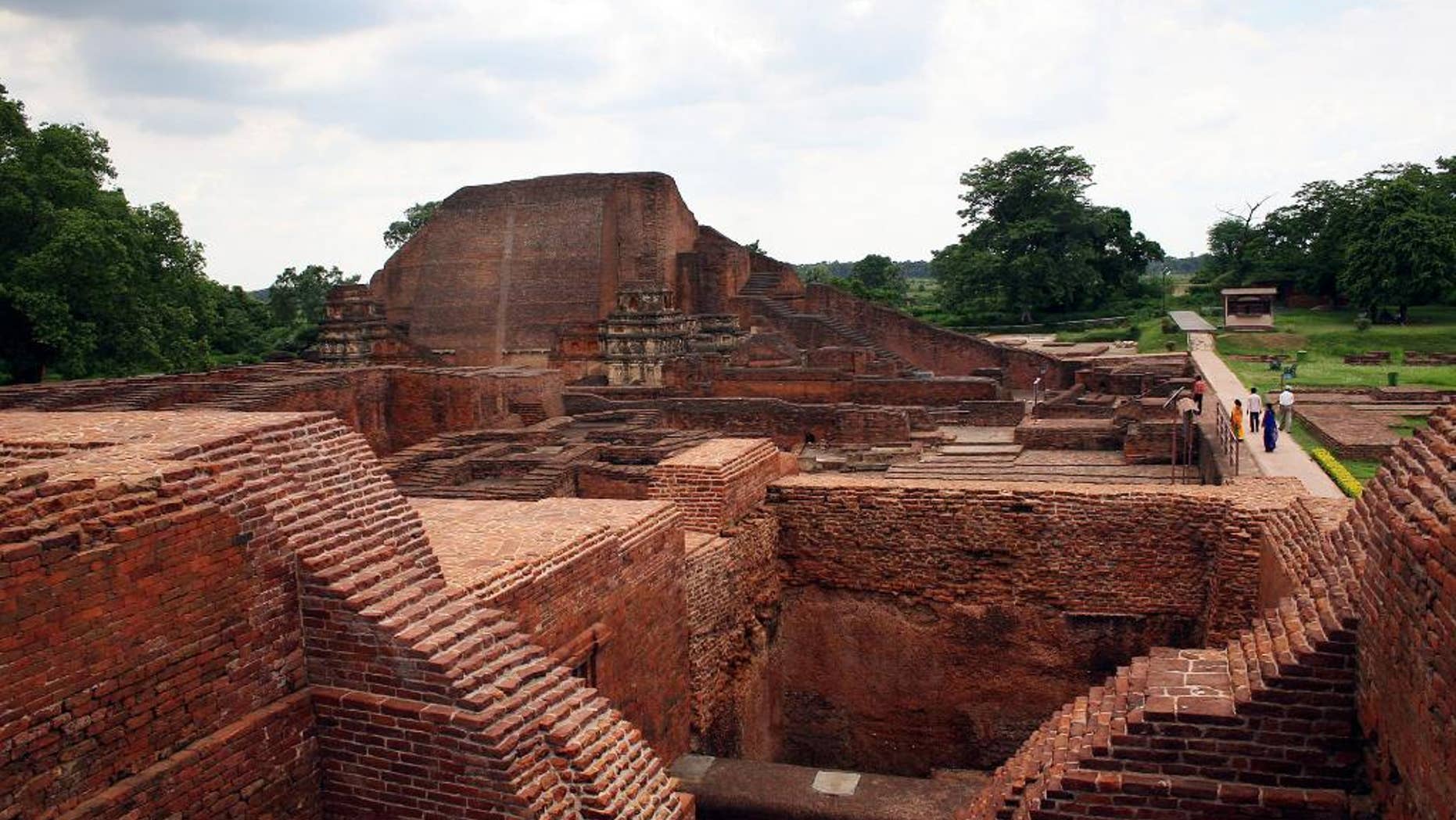 FILE � In this July 5, 2006 file photo, tourists walk at the ruins of the Nalanda University at Nalanda, India. UNESCO has put four new sites on its World Heritage List, including the archaeological site of Nalanda Mahavihara, or Nalanda University, on Friday, July 15, 2016. (AP Photo/Prashant Ravi, File)