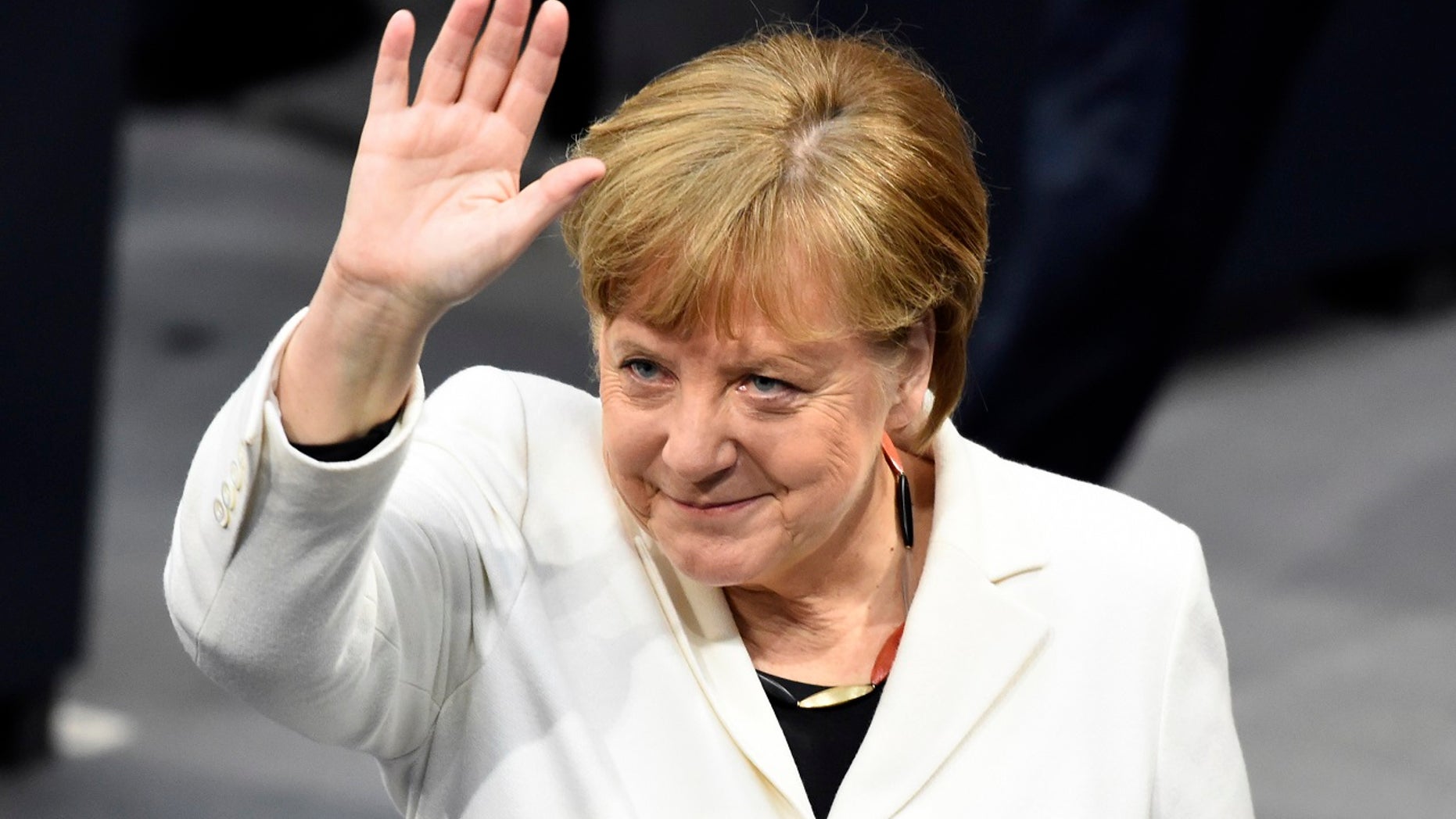 German Chancellor Angela Merkel waves when Germany's parliament Bundestag meets to elect Angela Merkel for a fourth term as chancellor in Berlin, Germany, Wednesday, March 14, 2018. (Gregor Fischer/dpa via AP)