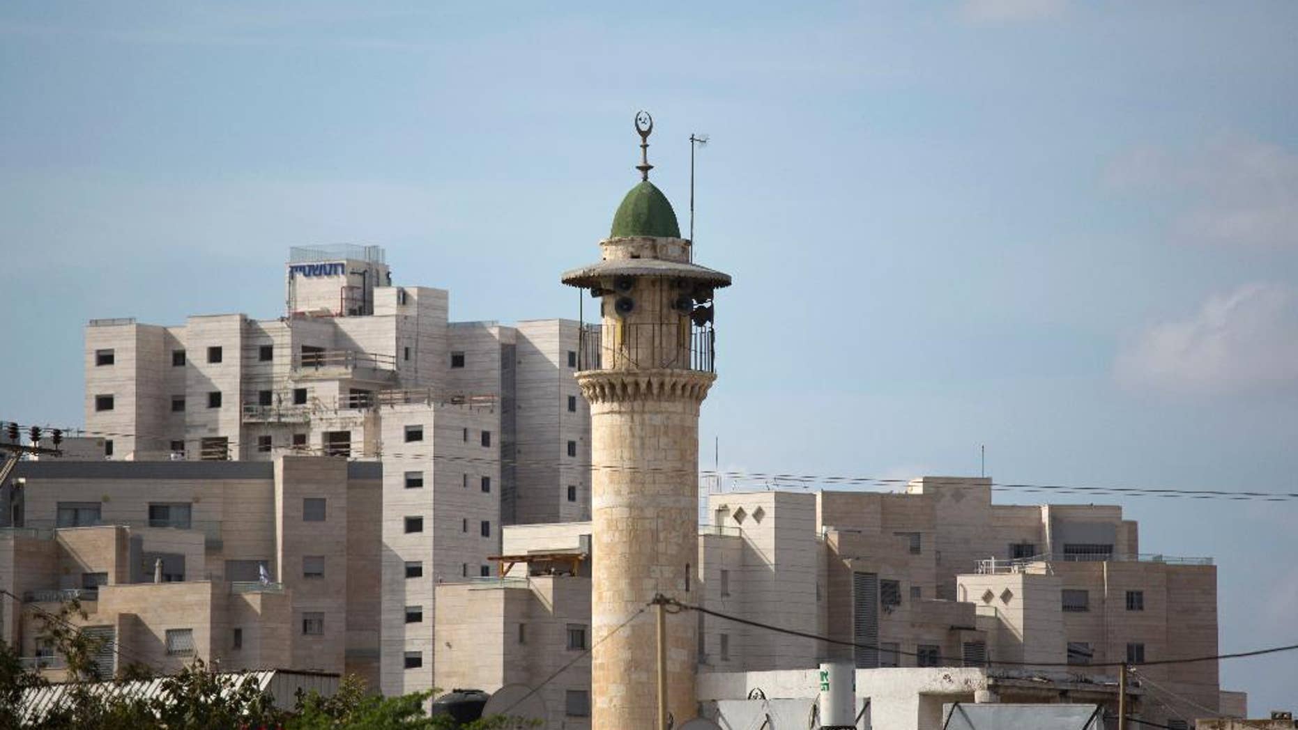FILE -- In this Nov. 16, 2016 file photo, the minaret of a mosque is seen in Lod, a mixed Jewish Muslim and Christian city in central Israel. On wedneday, March 8, 2017, Israel's parliament passed an initial reading of a bill that would make mosques lower the volume of their call to prayer, amid protests by Arab lawmakers. Arab-Israeli politician Ahmed Tibi tore up the proposal at the Knesset podium Wednesday. The bill still needs to pass several more hurdles. (AP Photo/Ariel Schalit, File)