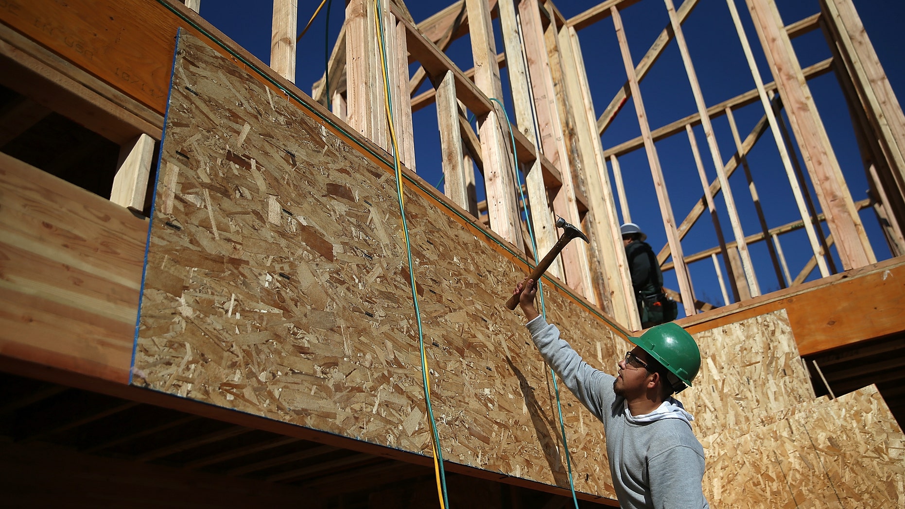 PETALUMA, CA - JANUARY 21: A worker hammers nails as he builds a new home on January 21, 2015 in Petaluma, California. According to a Commerce Department report, construction of new homes increased 4.4 percent in December, pushing building of new homes to the highest level in nine years. (Photo by Justin Sullivan/Getty Images)