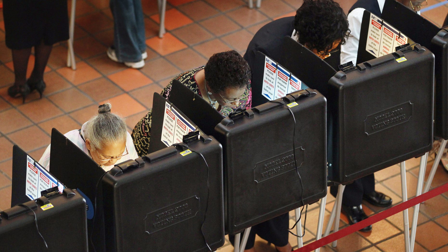 MIAMI - OCTOBER 18: People cast their votes at a polling station set up at the Miami-Dade Government Center on October 18, 2010 in Miami, Florida. Florida residents headed to the polls to cast votes on the first day of early voting in teh midterm elections. (Photo by Joe Raedle/Getty Images)