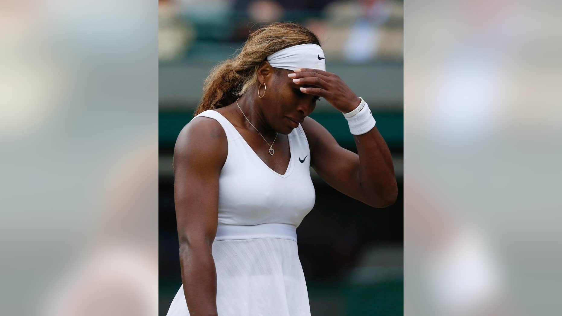Serena Williams of U.S. gestures after losing a point to Alize Cornet of France during their women's singles match at the All England Lawn Tennis Championships in Wimbledon, London, Saturday, June 28, 2014. (AP Photo/Sang Tan)