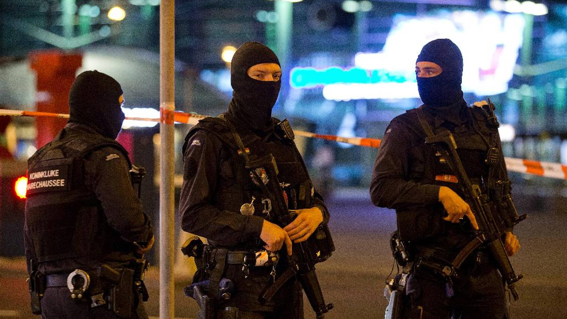 FILE - This is a Wednesday, April 13, 2016 file photo of hooded military police officers guard a part of Schiphol Aiport in Amsterdam, Netherlands. Dutch authorities said Thursday Aug. 17, 2016 that beefed-up security measures at Amsterdam's Schiphol Airport are being scaled back following recent investigation of an unspecified threat. The country's National Coordinator of Counterterrorism and Security says in a statement that some of the extra measures, which included military police checking cars approaching the airport to drop off passengers, will end Thursday evening, just under three weeks after they were introduced. (AP Photo/Peter Dejong, File)