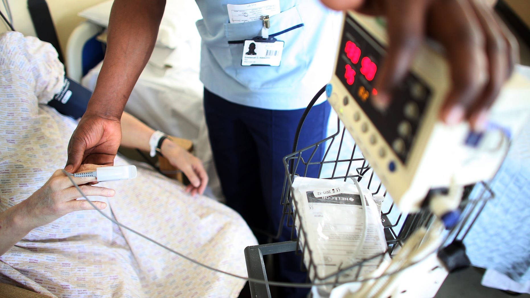 BIRMINGHAM, ENGLAND - MARCH 16: A nurse tends to recovering patients on a general ward at The Queen Elizabeth Hospital on March 16, 2010 in Birmingham, England. As the UK gears up for one of the most hotly contested general elections in recent history it is expected that that the economy, immigration, industry, the NHS and education are likely to form the basis of many of the debates. (Photo by Christopher Furlong/Getty Images)