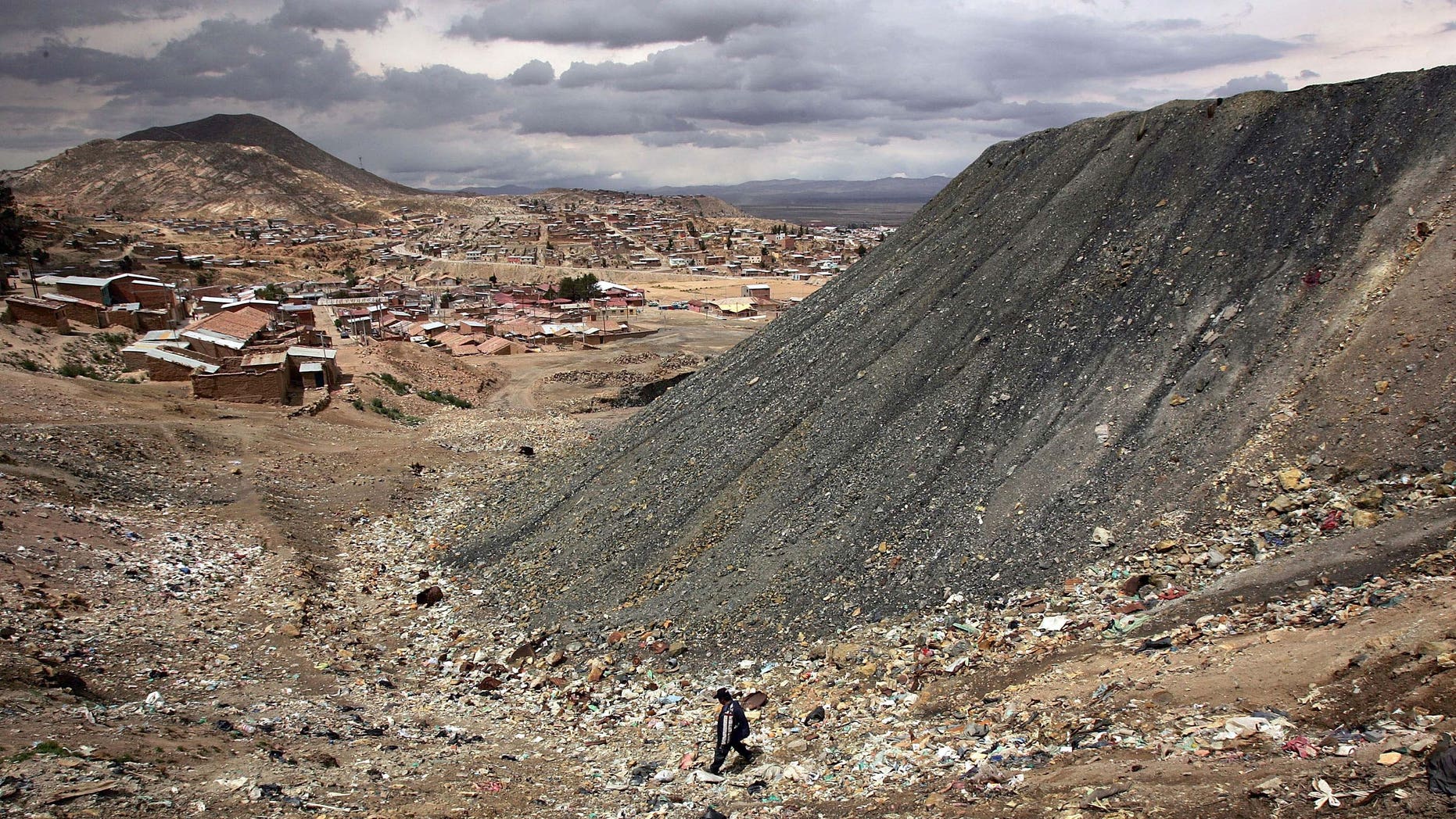 ORURO, BOLIVIA - DECEMBER 14: A miner walks past a mountain of deposits from the San Jose Mine December 14, 2005 in Oruro, Bolivia. Miners, a crucial sector of Bolivian society, have been a commanding force in the upcoming presidential elections in Bolivia, with most steadfastly behind candidate Evo Morales. Morales, a one time coca farmer and union leader, who offers what may become the most radical vision in Latin America, is leading in the polls for the presidential election which is scheduled to take place on December 18. Washington is paying close attention to the race as fears grow of yet another leftist government. (Photo by Spencer Platt/Getty Images)