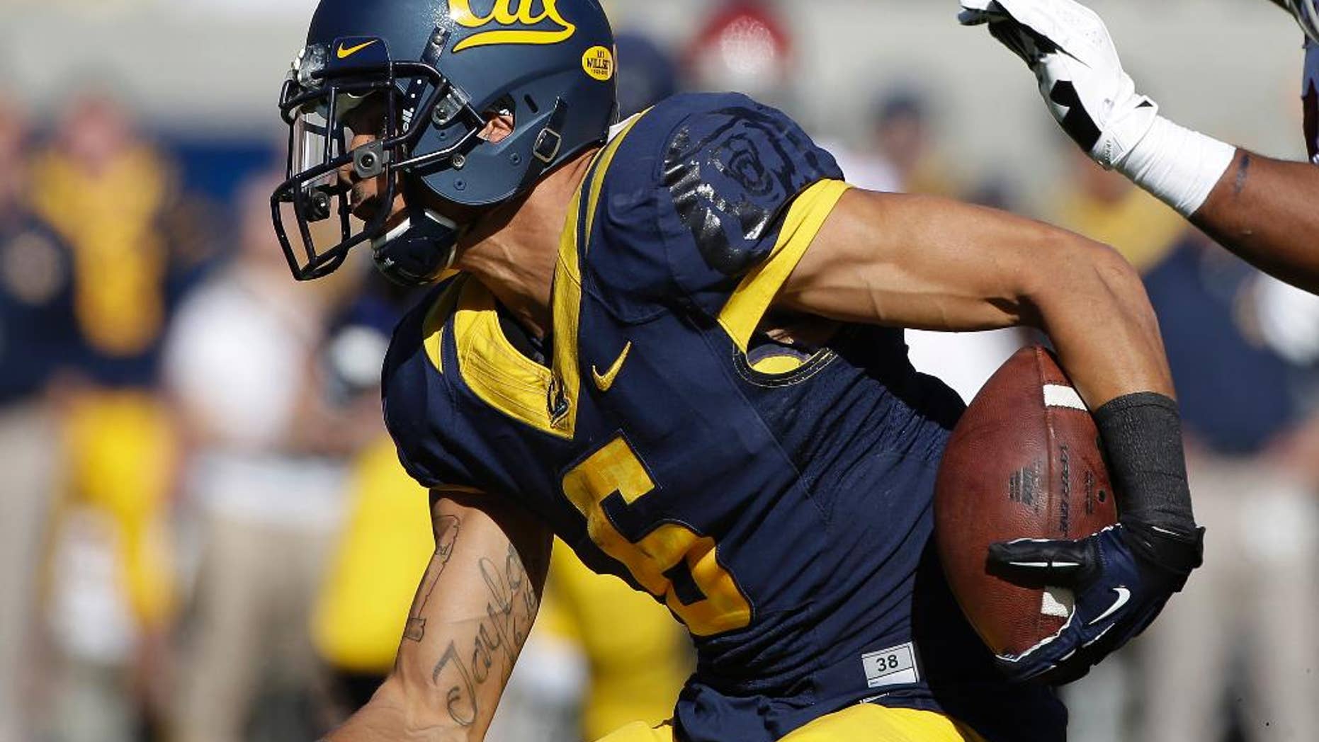 FILE - This Nov. 9, 2013, file phot,o shows California wide receiver Chris Harper runninh with the ball during the first quarter of an NCAA college football game in Berkeley, Calif. The players are excited about practice, focused on football and eager to put last season's disappointing one-win campaign far in the past. "It's a whole different environment," receiver Harper said. "Everybody is pumped up, everybody is energetic, everybody wants to be here. There's no one on the team that I can say doesn't want to be here. Last year there were a couple of guys that weren't feeling it.” (AP Photo/Eric Risberg,File)