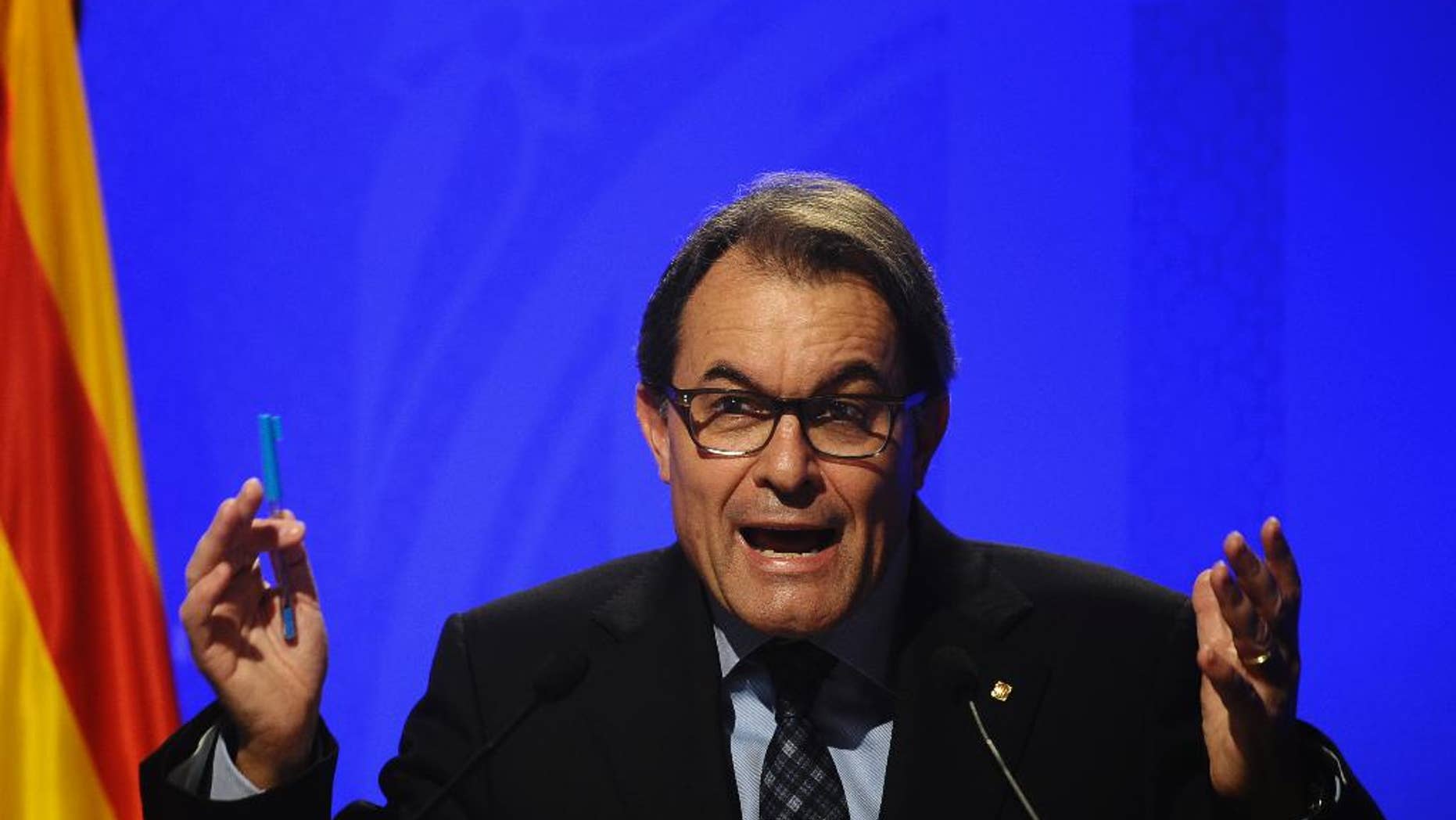 Catalonia's regional president Artur Mas gestures during a press conference at the Generalitat Palace in Barcelona, Spain, Tuesday, Nov. 11, 2014. The Catalonia region's president was riding a wave of enthusiasm among independence seekers Monday, a day after a non-binding vote on secession from Spain showed strong though not overwhelming support for breaking away. Mas opted for an unofficial consultation after parliament, where Rajoy's Popular Party has a majority, rejected his call for a referendum and Spain's judiciary concurred. (AP Photo/Manu Fernandez)