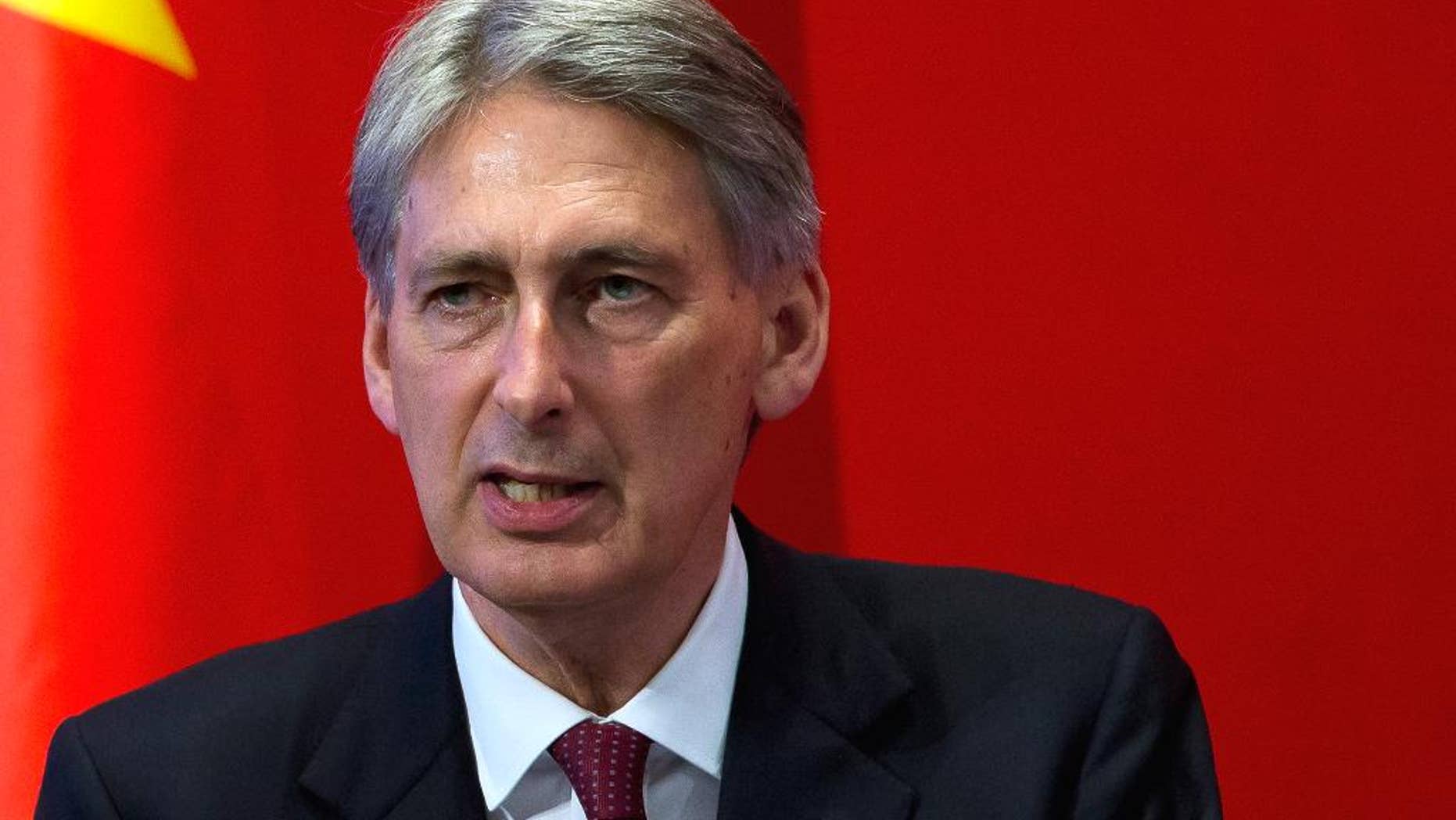 FILE- In this Aug. 12, 2015, file photo, British Foreign Secretary Philip Hammond delivers his speech at Peking University in Beijing. Hammond confirmed the release of a British hostage, Douglas Robert Semple, by UAE forces in a military intelligence operation on Sunday, Aug. 23. "The British national is safe and well, and is receiving support from British government officials," said Hammond. (AP Photo/Andy Wong, File)
