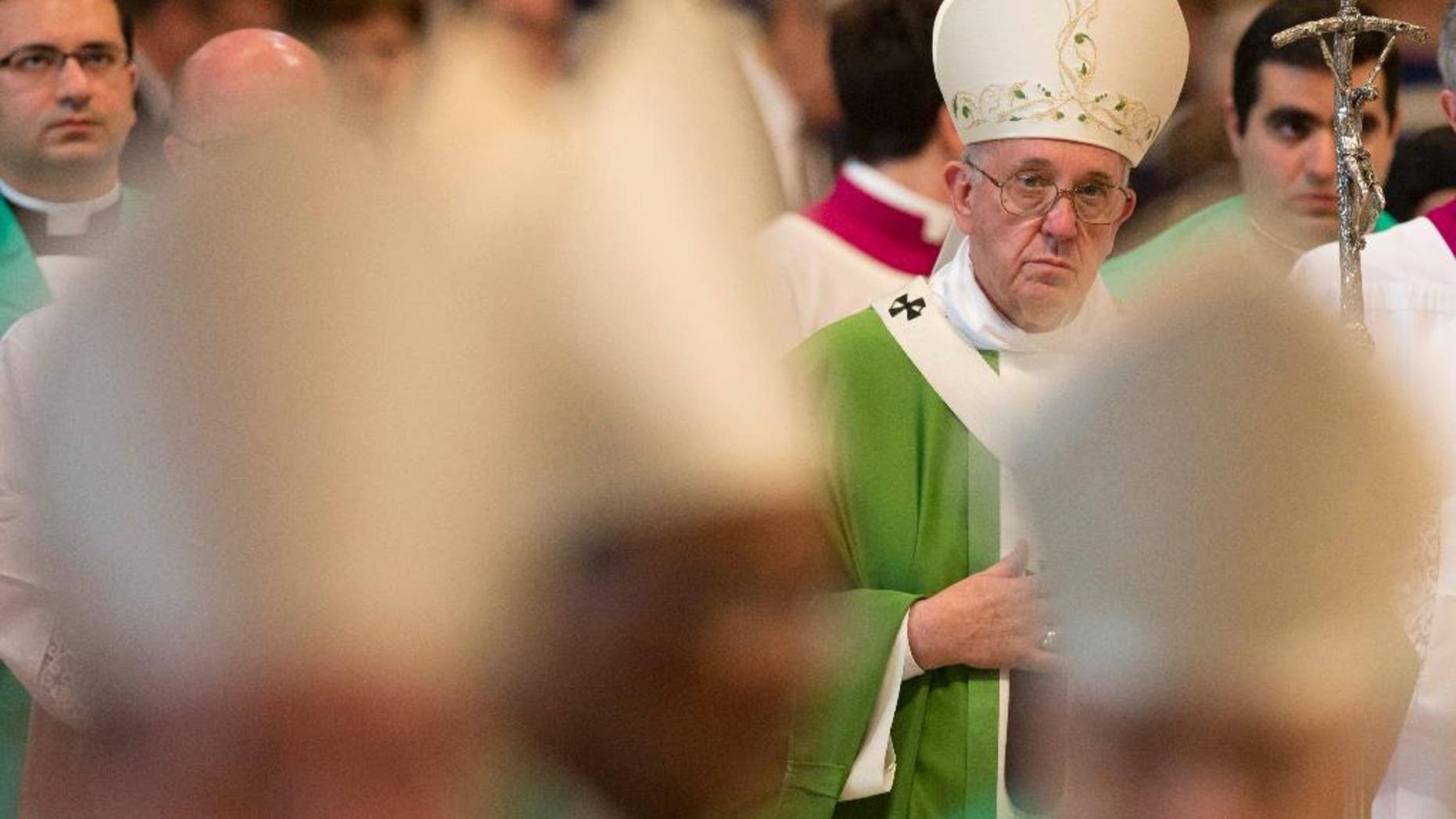 Pope Francis leaves after celebrating a Mass in St. Peter's Basilica at the Vatican, Sunday, Oct. 25, 2015. Pope Francis declared Sunday that "Today is a time of mercy!" as he closed out a historic meeting of bishops that approved an important new direction in welcoming divorced and civilly remarried Catholics into the church. (AP Photo/Alessandra Tarantino)