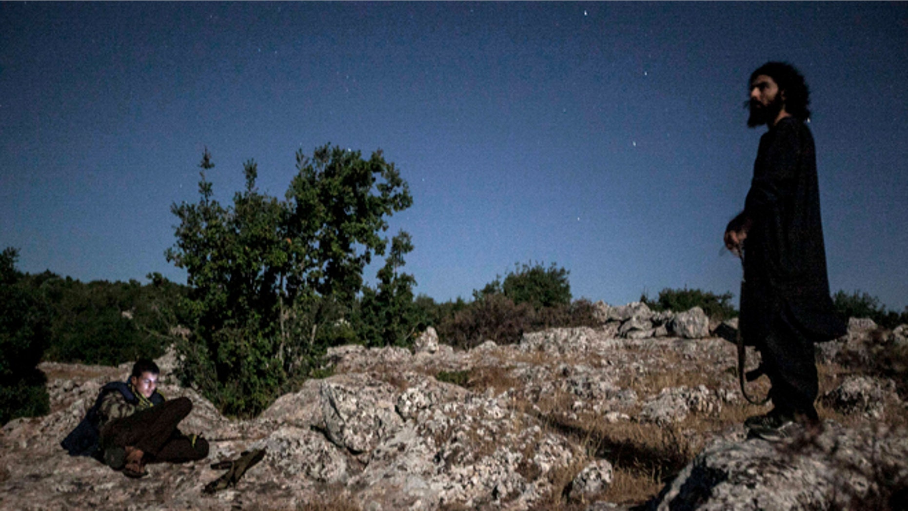 Sept. 18, 2013: Syrian opposition fighters are seen at the top of a mountain in the vicinity of a rebel camp in Idlib province, Syria.