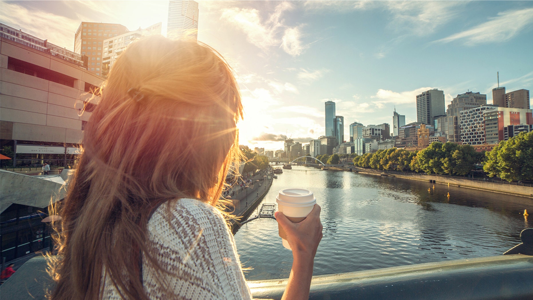 A woman enjoys the sunrise in Melbourne, Australia.