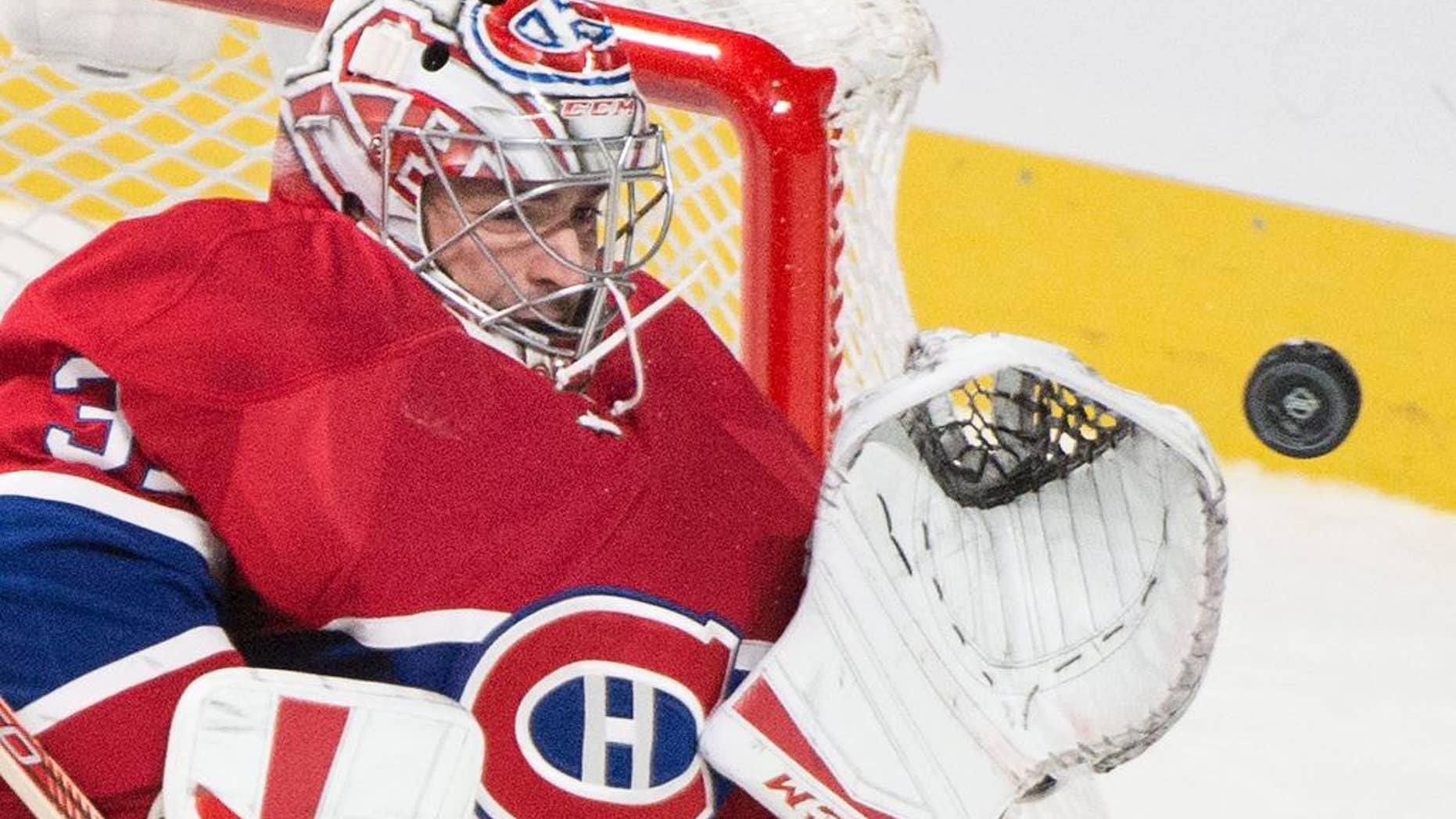 FILE - In this Oct. 20, 2015, file photo, Montreal Canadiens goaltender Carey Price makes a save against the St. Louis Blues during the third period of an NHL hockey game, in Montreal. The Montreal Canadiens say goaltender Carey Price and defenseman P.K. Subban will not play in the final two games of the season. The club revealed Price has been out with a sprained medial collateral ligament sprain in his right knee suffered Nov. 25 against the New York Rangers. Subban, Montreal’s top defenseman, has been out since suffering a neck injury March 10 against Buffalo.(Graham Hughes/The Canadian Press via AP, File) MANDATORY CREDIT