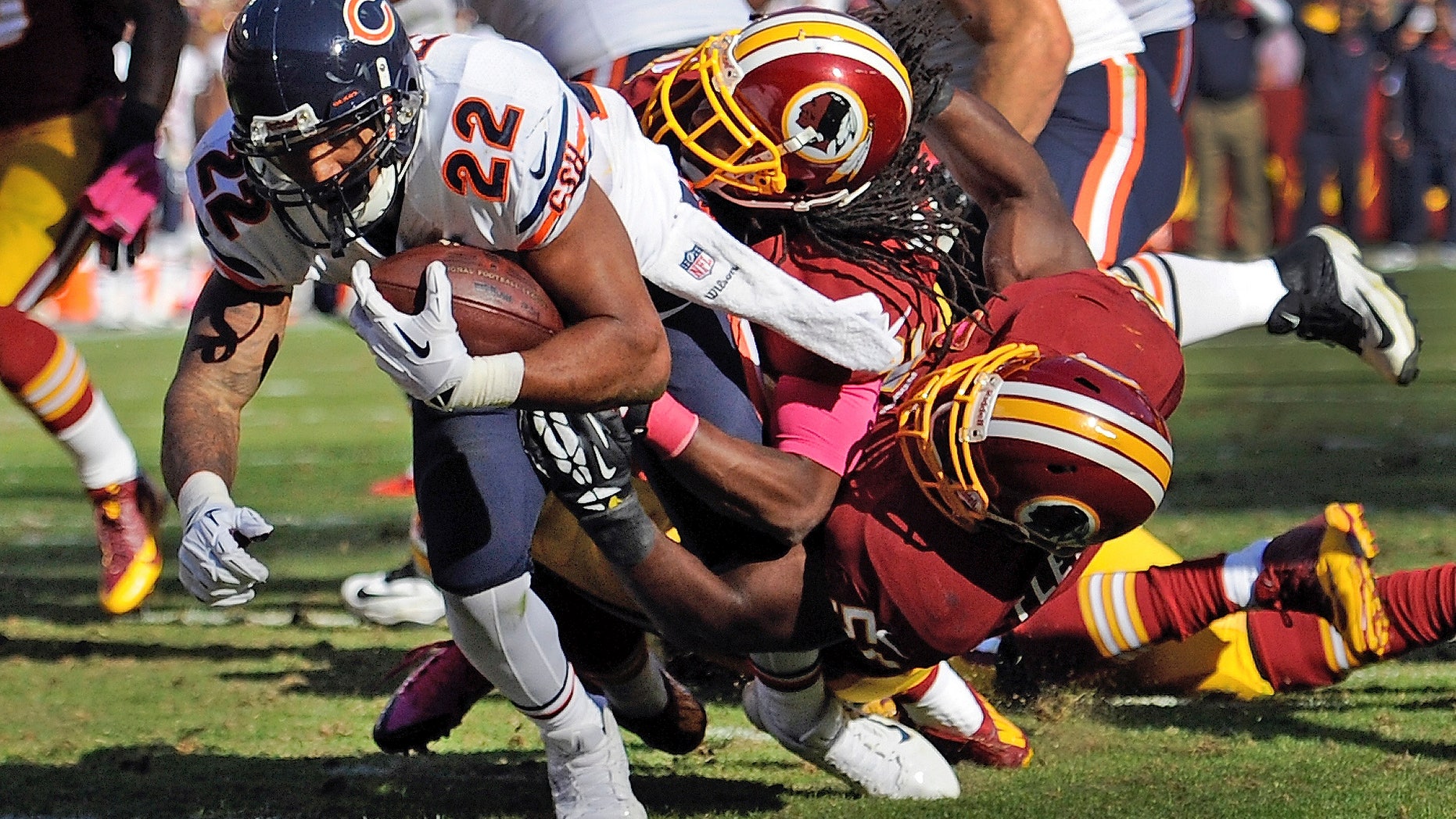 Chicago Bears running back Matt Forte (22) drags Washington Redskins strong safety Brandon Meriweather, center, and inside linebacker London Fletcher, right, into the end zone for a touchdown during the second half of a NFL football game in Landover, Md., Sunday, Oct. 20, 2013. (AP Photo/Nick Wass)