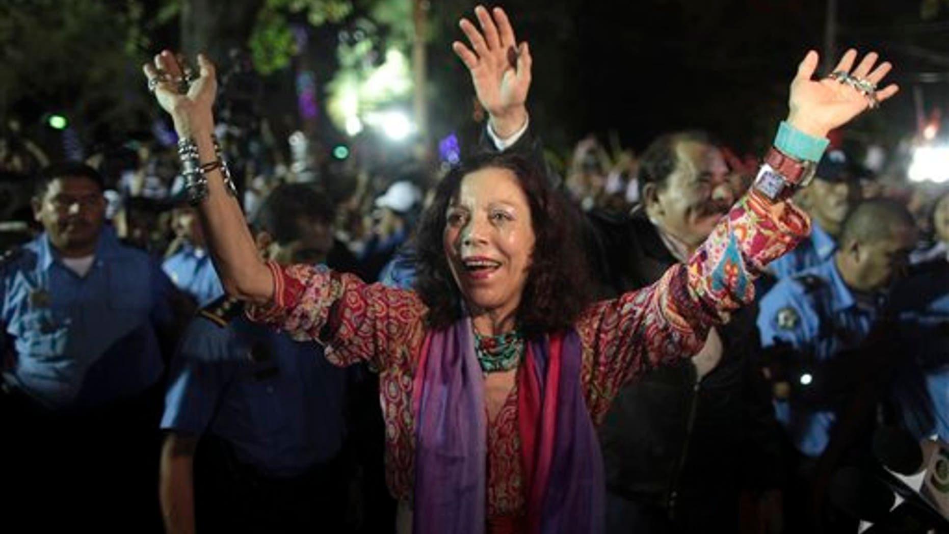 FILE - In this Nov. 8, 2011 file photo, Nicaragua's first lady Rosario Murillo waves to supporters next to her husband, President Daniel Ortega, in Revolution Square in Managua, Nicaragua.