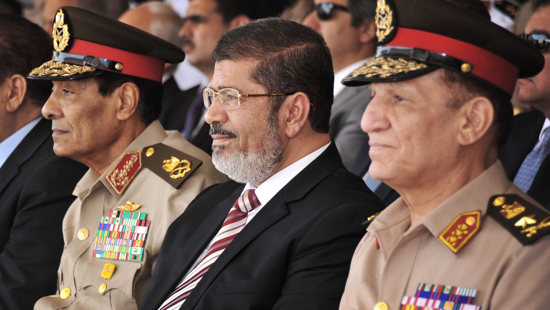 July 5, 2012: In this file image released by the Egyptian President, Egyptian Field Marshal Gen. Hussein Tantawi, left, new President Mohammed Morsi, center, and Armed Forces Chief of Staff Sami Anan, right, attend a medal ceremony, at a military base east of Cairo, Egypt. The spokesman for Egypts president says Mohammed Morsi, the countrys Islamist leader, has decided to retire the head of the Armed Forces and minister of Defense and chief of staff.