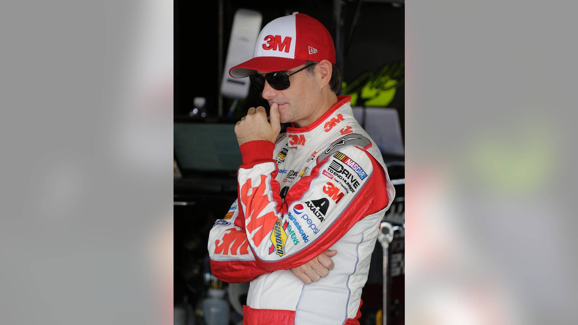 Jeff Gordon stands in the garage before a NASCAR Sprint Cup practice session at Darlington Raceway in Darlington, S.C., Friday, Sept. 4, 2015. (AP Photo/Terry Renna)