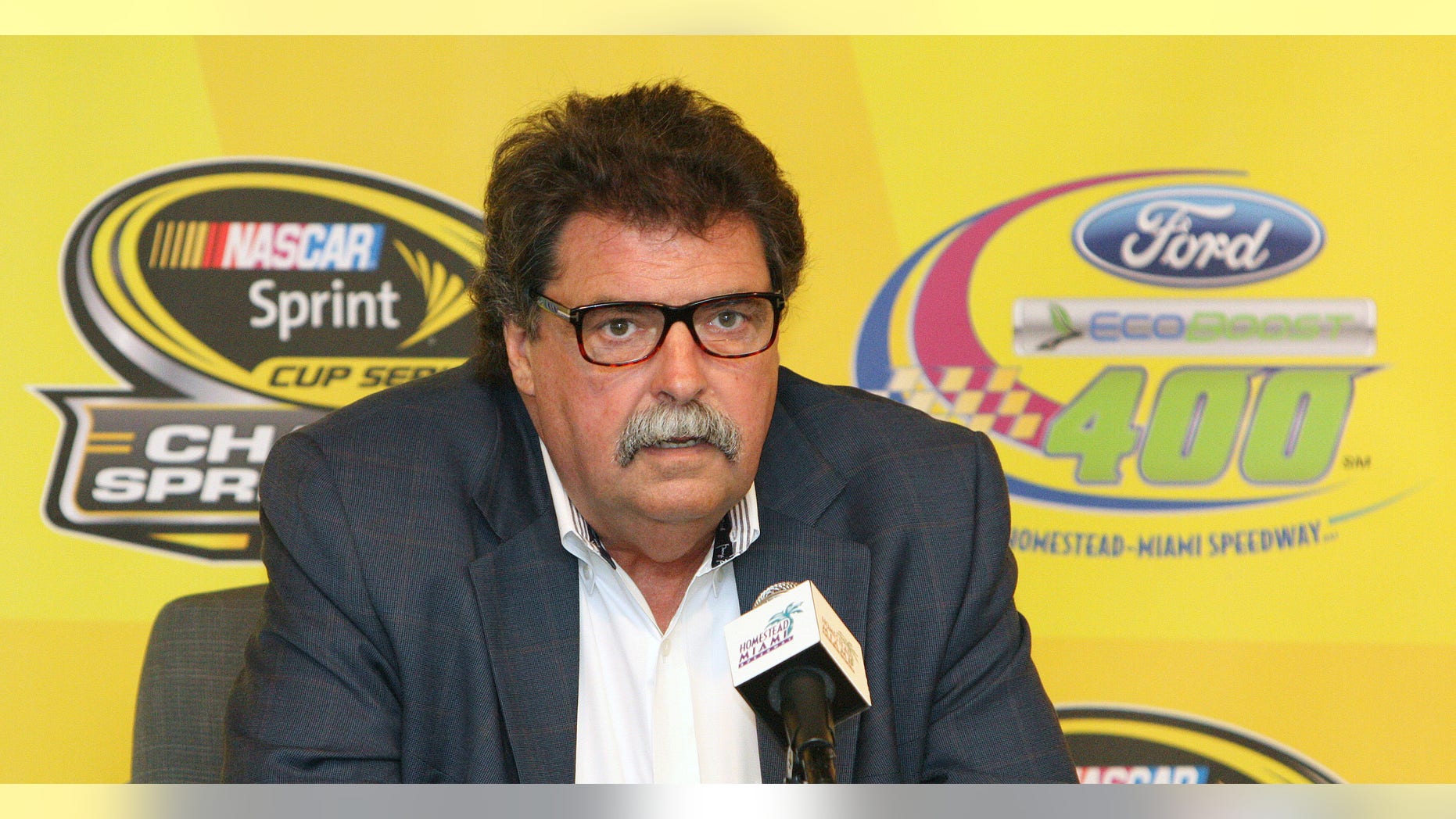 NASCAR president Mike Helton talks to the media during a news conference at the NASCAR championship weekend auto races in Homestead, Fla., Friday, Nov. 15, 2013. (AP Photo/Darryl Graham)