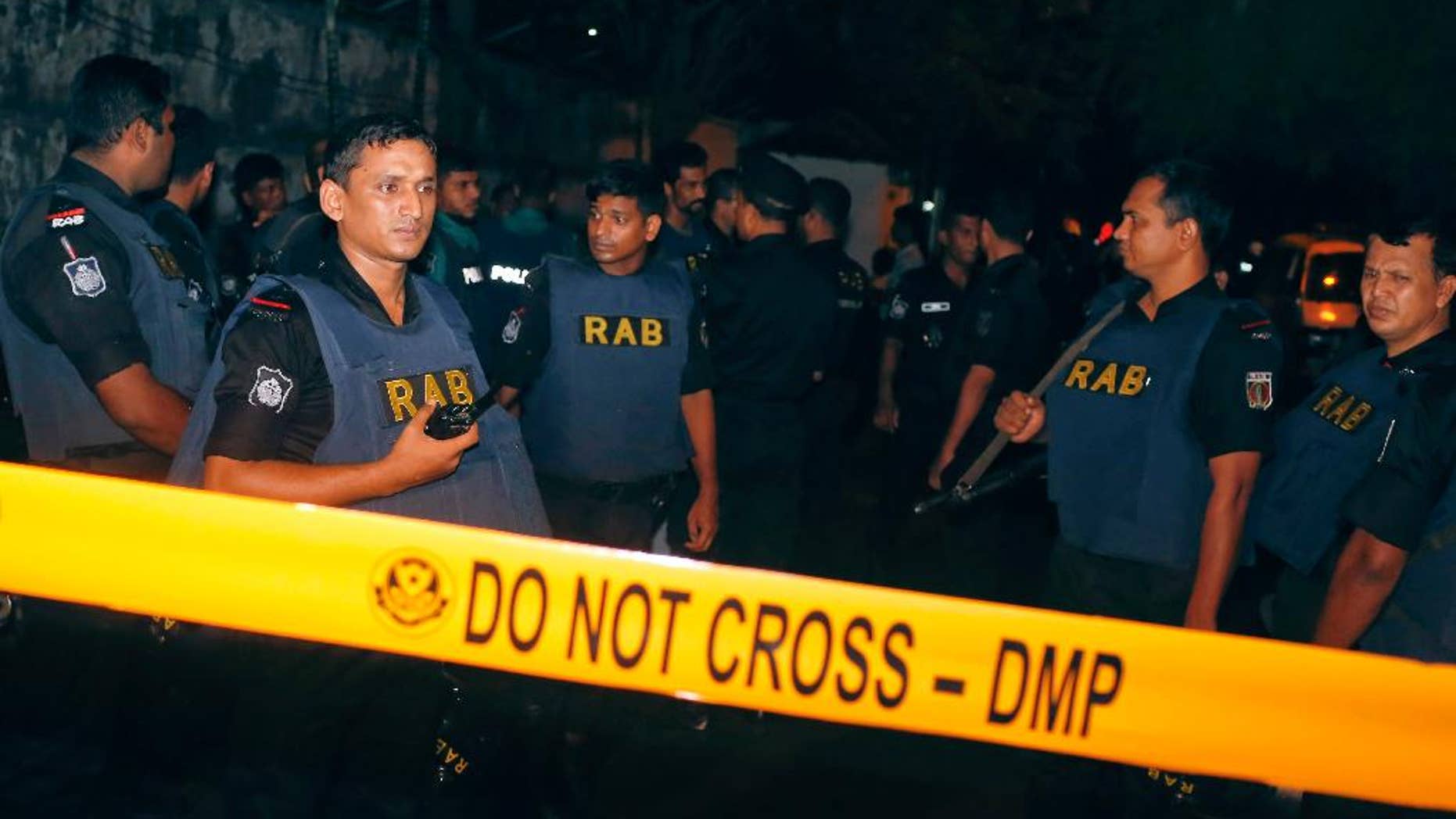 Bangladeshi security officers cordon off an area after heavily armed militants attacked a restaurant in Bangladesh's diplomatic zone on Friday night, in Dhaka, Bangladesh, Saturday, July 2, 2016. Bangladeshi forces stormed the popular Holey Artisan Bakery in Dhaka's Gulshan area to end a hostage-taking early Saturday. (AP Photo)