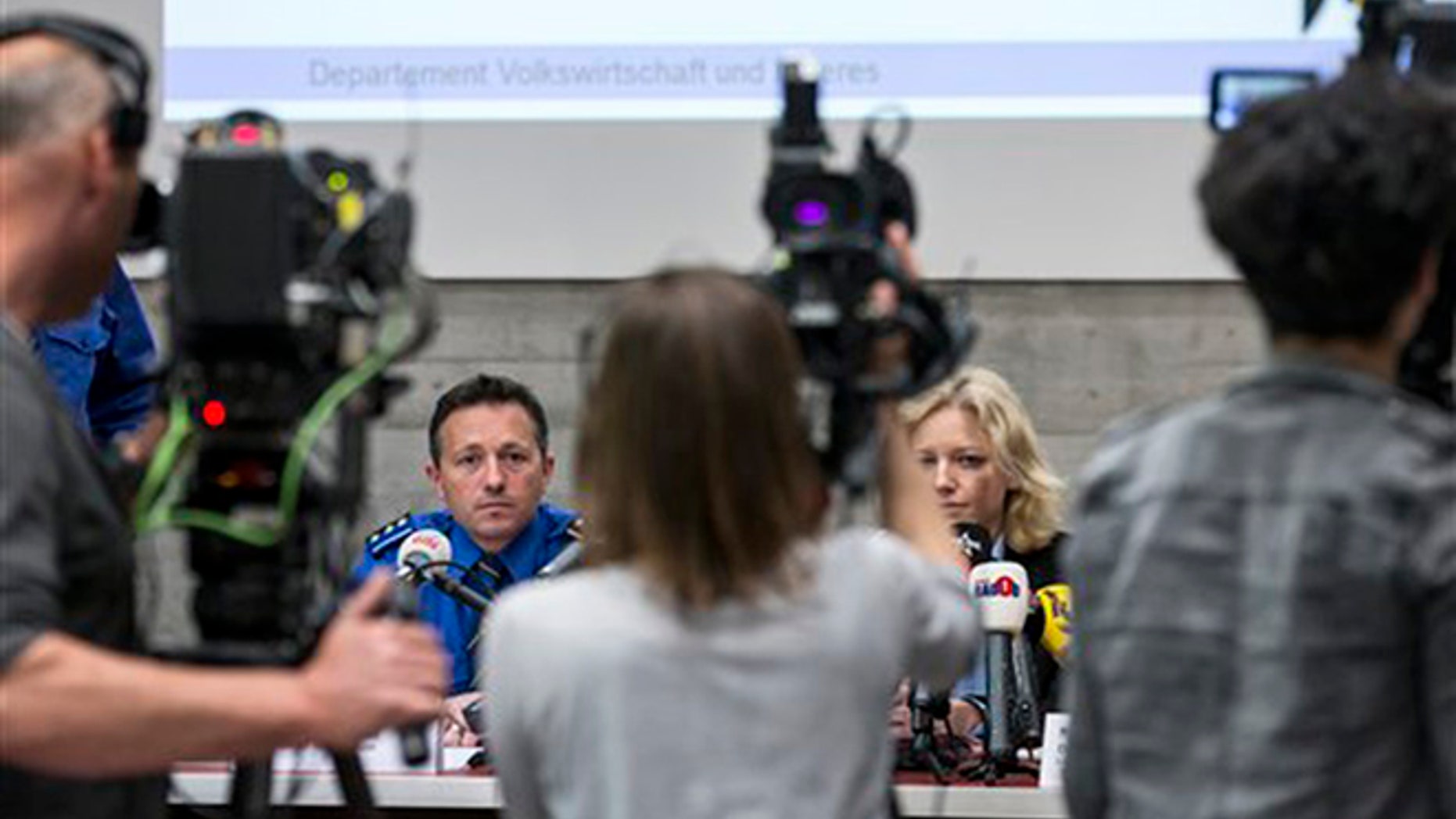 Police captain Markus Gisin, left, and prosecutor Barbara Loppacher, right inform the media in Schafisheim, Switzerland. about the killing of a family in Rupperswil in December. Officials in the nearby Swiss town of Rupperswil are expressing shock after the arrest of a 33-year-old soccer coach over the killing of four people. (AP)