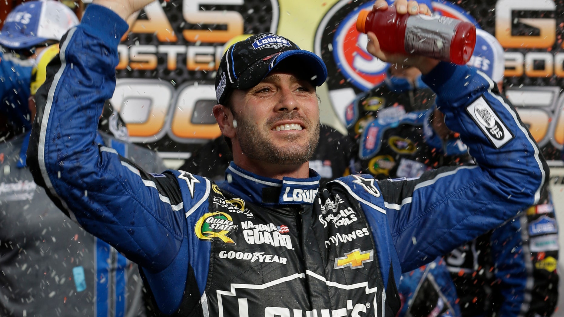Jimmie Johnson celebrates after winning the STP 500 NASCAR Sprint Cup series auto race at Martinsville Speedway in Martinsville, Va., Sunday, April 7, 2013. (AP Photo/Steve Helber)