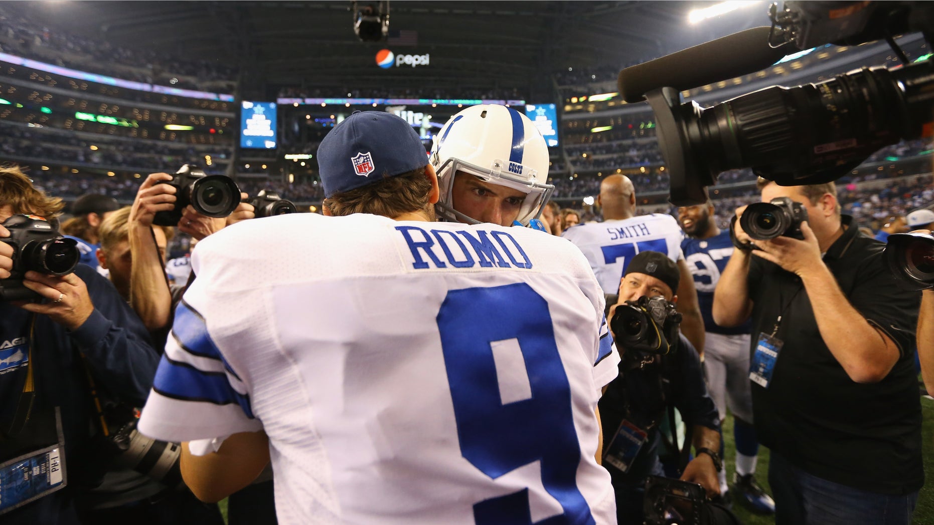ARLINGTON, TX - DECEMBER 21: Tony Romo #9 of the Dallas Cowboys greets Andrew Luck #12 of the Indianapolis Colts after play at AT&T Stadium on December 21, 2014 in Arlington, Texas. (Photo by Ronald Martinez/Getty Images)