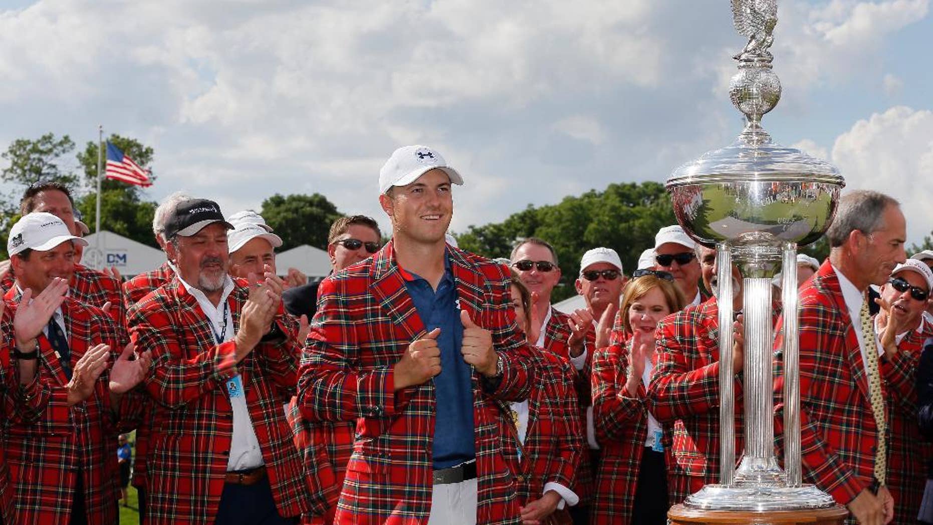 Jordan Spieth poses for photos after being presented with the plead jacket after winning the Dean & DeLuca Invitational golf tournament at Colonial, Sunday, May 29, 2016, in Fort Worth, Texas. (AP Photo/Tony Gutierrez)