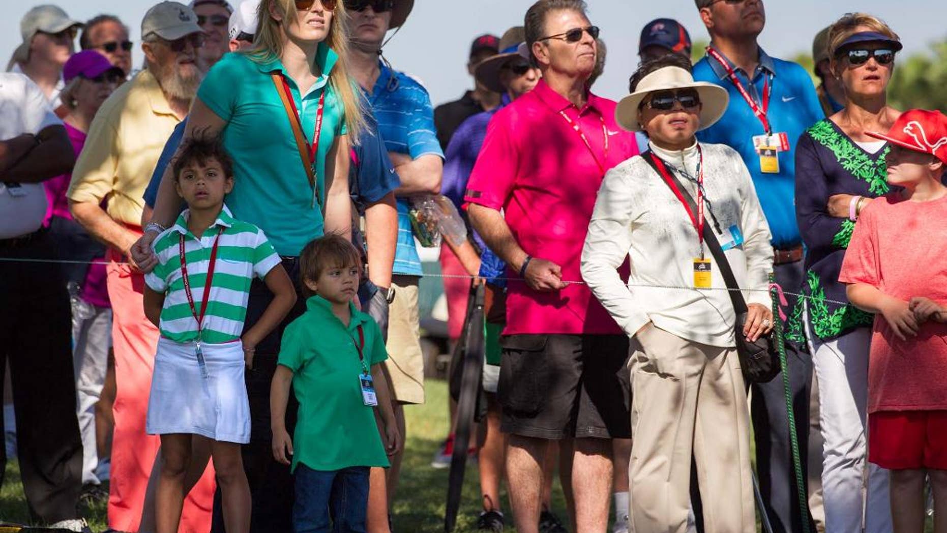 Lindsey Vonn, joined by Tiger Woods' children, Sam Alexis and Charlie Axel, watches Woods tee off on the 11th hole during the second round of the Honda Classic golf tournament in Palm Beach Gardens, Fla., Friday, Feb. 28, 2014. (AP Photo/The Palm Beach Post, Allen Eyestone) MAGS OUT NO SALES TV OUT