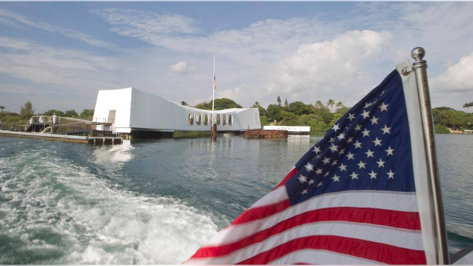 FILE - This Dec. 7, 2012 file photo shows The USS Arizona Memorial at Pearl Harbor, Hawaii. The Navy has investigated the case of a sailor who didn't salute as the national anthem played during a morning flag-raising at Pearl Harbor on Monday, Sept. 19, 2016. (AP Photo/Eugene Tanner, File)