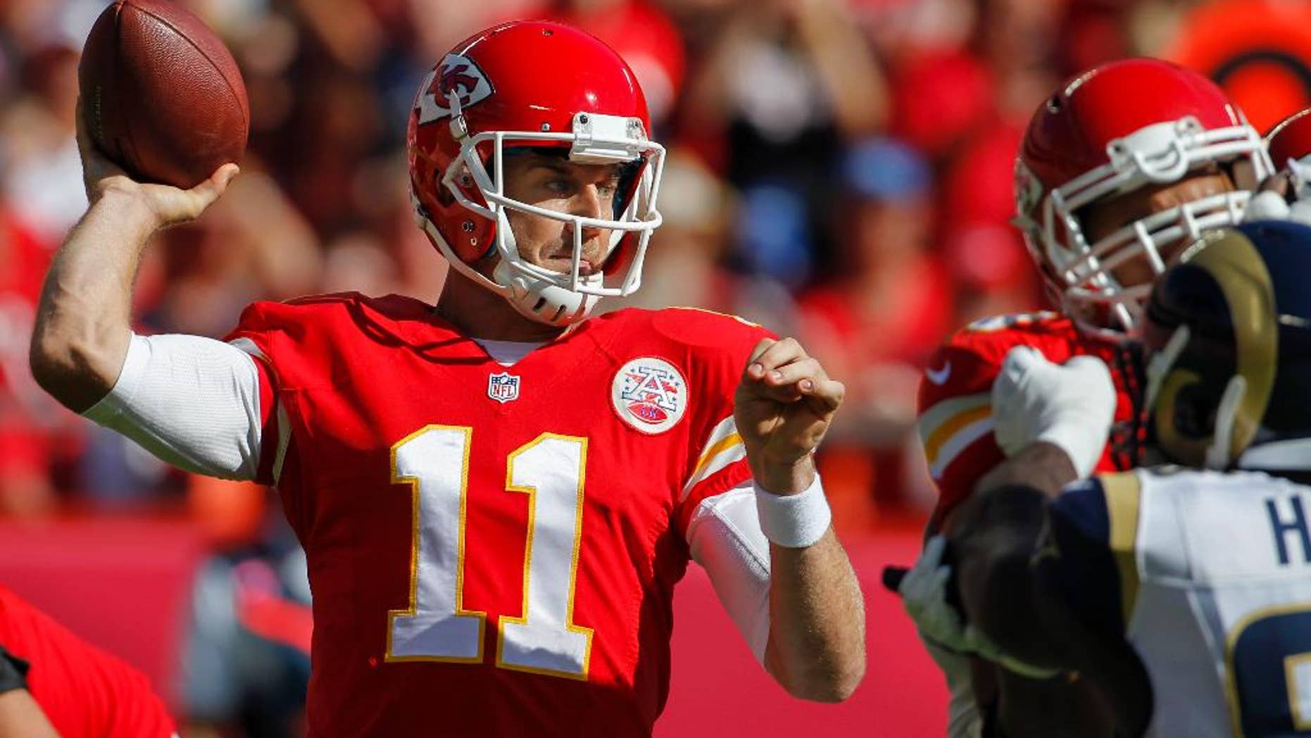 Kansas City Chiefs quarterback Alex Smith (11) throws in the first half of an NFL football game against the St. Louis Rams in Kansas City, Mo., Sunday, Oct. 26, 2014. (AP Photo/Colin E. Braley)
