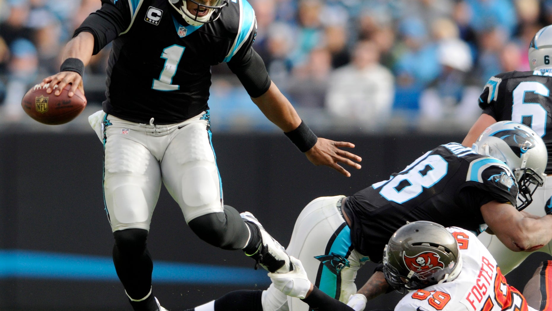 Carolina Panthers' Cam Newton (1) dodges Tampa Bay Buccaneers' Mason Foster (59) in the first half of an NFL football game in Charlotte, N.C., Sunday, Dec. 1, 2013. (AP Photo/Mike McCarn)