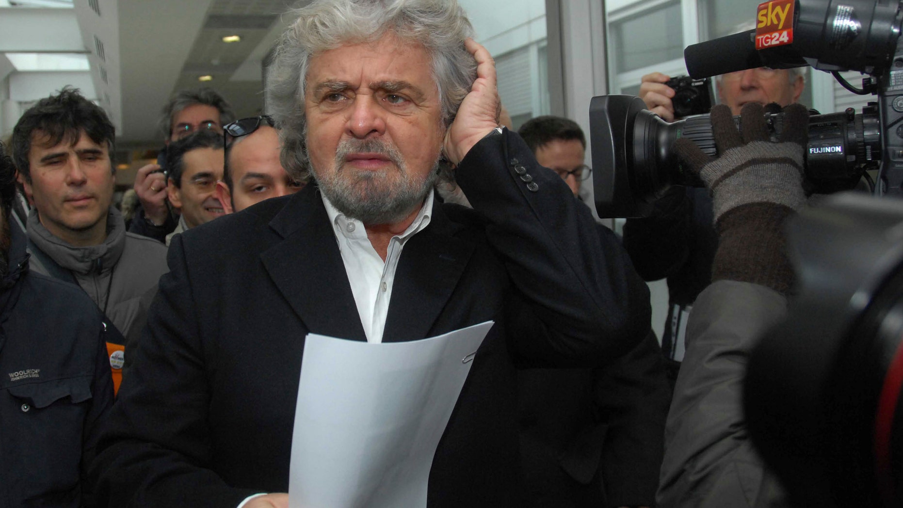 Five Stars movement leader Beppe Grillo arrives in Siena, Italy, Friday, Jan. 25, 2013, to participate in a meeting of shareholders of embattled Italian bank Monte dei Paschi di Siena, who lining up to question managers about a scandal involving potential trading losses that had reportedly been concealed. The world's oldest running bank convened shareholders Friday in Siena to approve capital increases as a condition to receive up to €3.9 billion ($5.22 billion) in state aid. The scandal over the trades caused shares to plunge this week and became a flashpoint in the campaign for national elections. (AP Photo/Riccardo Sanesi, Lapresse) ITALY OUT