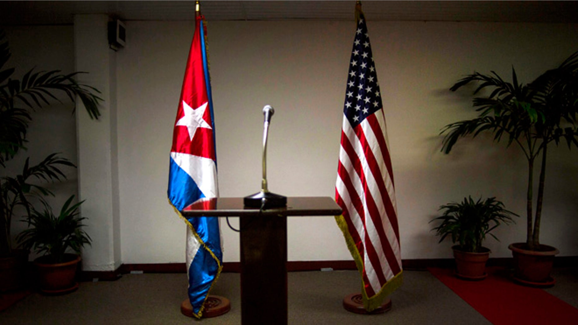 FILE - In this Jan. 22, 2015 file photo, a Cuban and U.S. flag stand before the start of a press conference on the sidelines of talks between the two nations in Havana, Cuba. The U.S. hopes to open an embassy in Havana before presidents Barack Obama and Raul Castro meet at a regional summit in April, which will be the scene of the presidentsâ first face-to-face meeting since they announced on Dec. 17 that they will re-establish diplomatic relations after a half-century of hostility. (AP Photo/Ramon Espinosa, File)