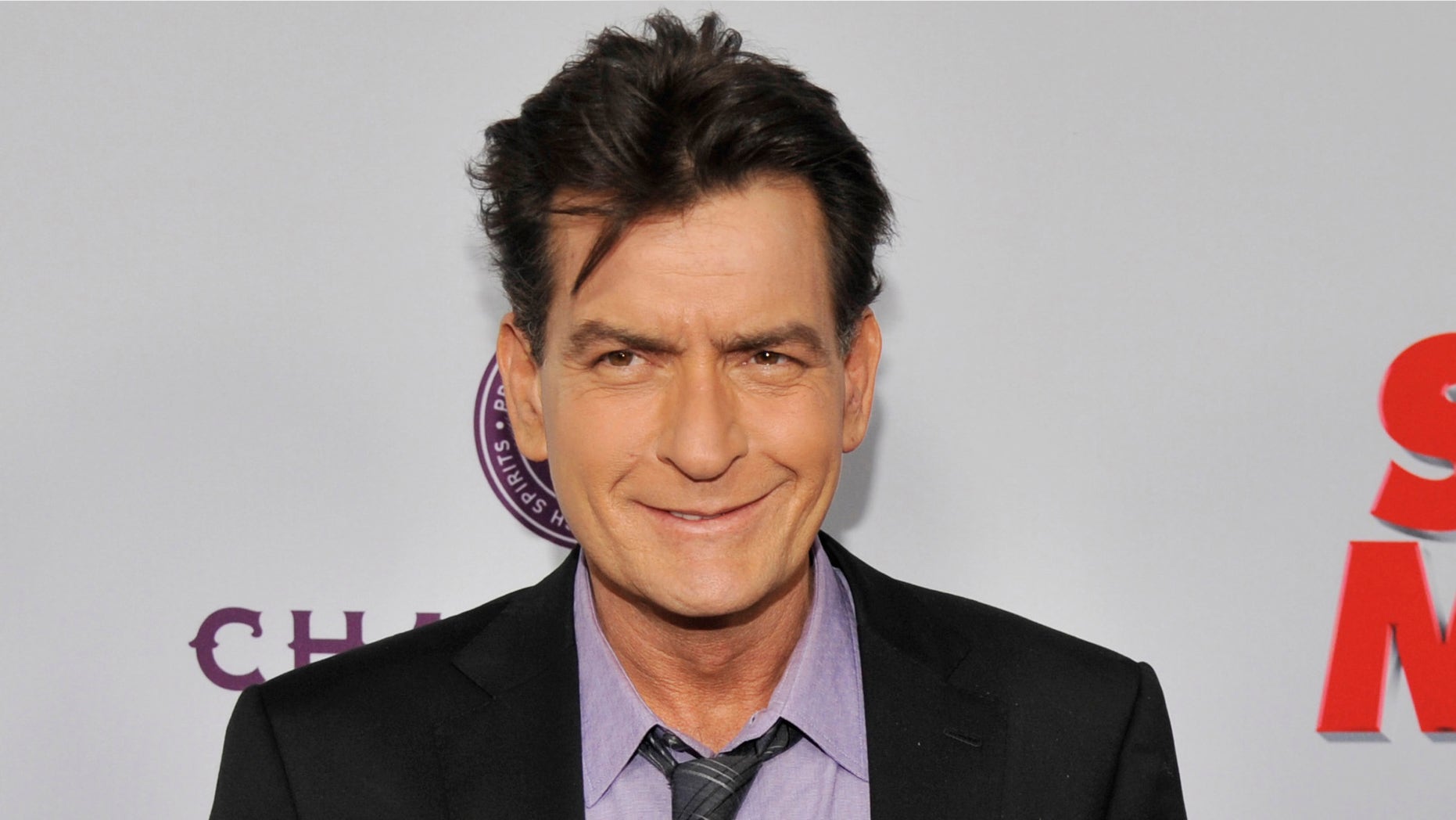 FILE - In this April 11, 2013 file photo, Charlie Sheen, a cast member in "Scary Movie V," poses at the Los Angeles premiere of the film at the Cinerama Dome in Los Angeles. Sheen was sued in Los Angeles Friday, Oct. 3, 2014, by a dental technician who claims the actor punched her in the chest and was abusive during an office visit in late September. (Photo by Chris Pizzello/Invision/AP, file)