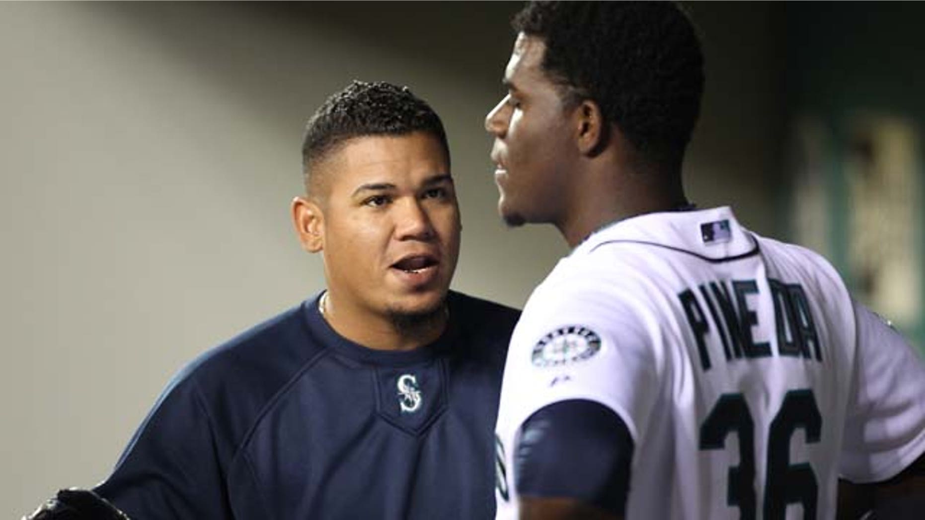 SEATTLE - APRIL 12: Felix Hernandez #34 of the Seattle Mariners talks with starting pitcher Michael Pineda #36 after he was removed from the game in the eighth inning against the Toronto Blue Jays at Safeco Field on April 12, 2011 in Seattle, Washington. The Mariners defeated the Blue Jays 3-2, and Pineda was credited with the win. (Photo by Otto Greule Jr/Getty Images)