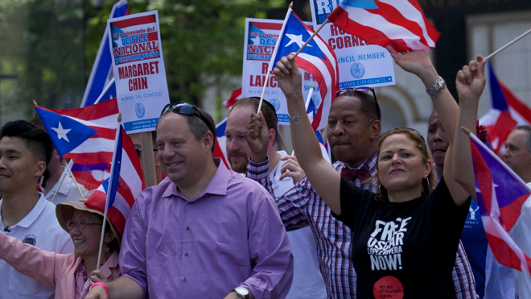 NYC Council Speaker Melissa Mark-Viverito wearing a black 'Free Oscar Lopez Rivera Now!' T-shirt.
