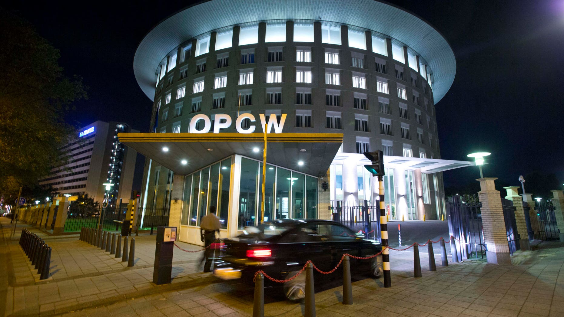 FILE - In this Friday Sept. 27, 2013 file photo a car arrives at the headquarters of the Organization for the Prohibition of Chemical Weapons, OPCW, in The Hague, Netherlands. The OPCW were awarded the Nobel Peace Prize on Friday, Oct. 11, 2013. (AP Photo/Peter Dejong, File)