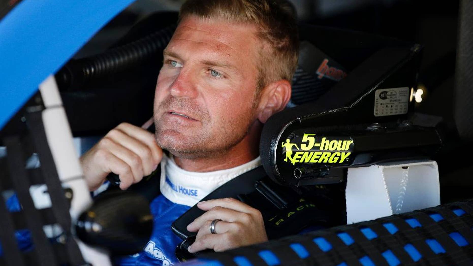 Clint Bowyer sits in his car before a practice session for Sunday's NASCAR Pocono 400 auto race, Friday, July 31, 2015, in Long Pond, Pa. (AP Photo/Matt Slocum)