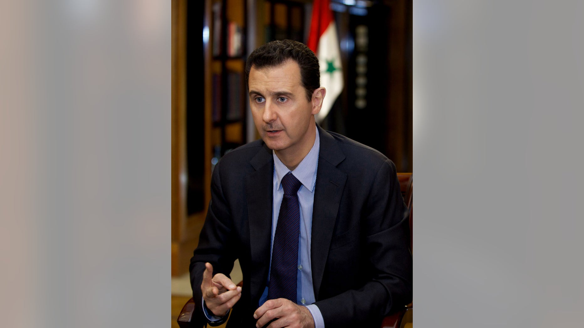 In this photo, which AP obtained from Syrian official news agency SANA and which has been authenticated based on its contents and other AP reporting, President Bashar Assad gestures as he speaks during an interview with Lebanon’s Al-Mayadeen TV, at the presidential palace in Damascus, Syria, Monday, Oct. 21, 2013. Syria’s president said Monday that the factors that would allow a landmark conference aimed at ending the country’s civil war do not yet exist, throwing further doubt on international efforts to hold peace talks that have already been repeatedly delayed. (AP Photo/SANA)