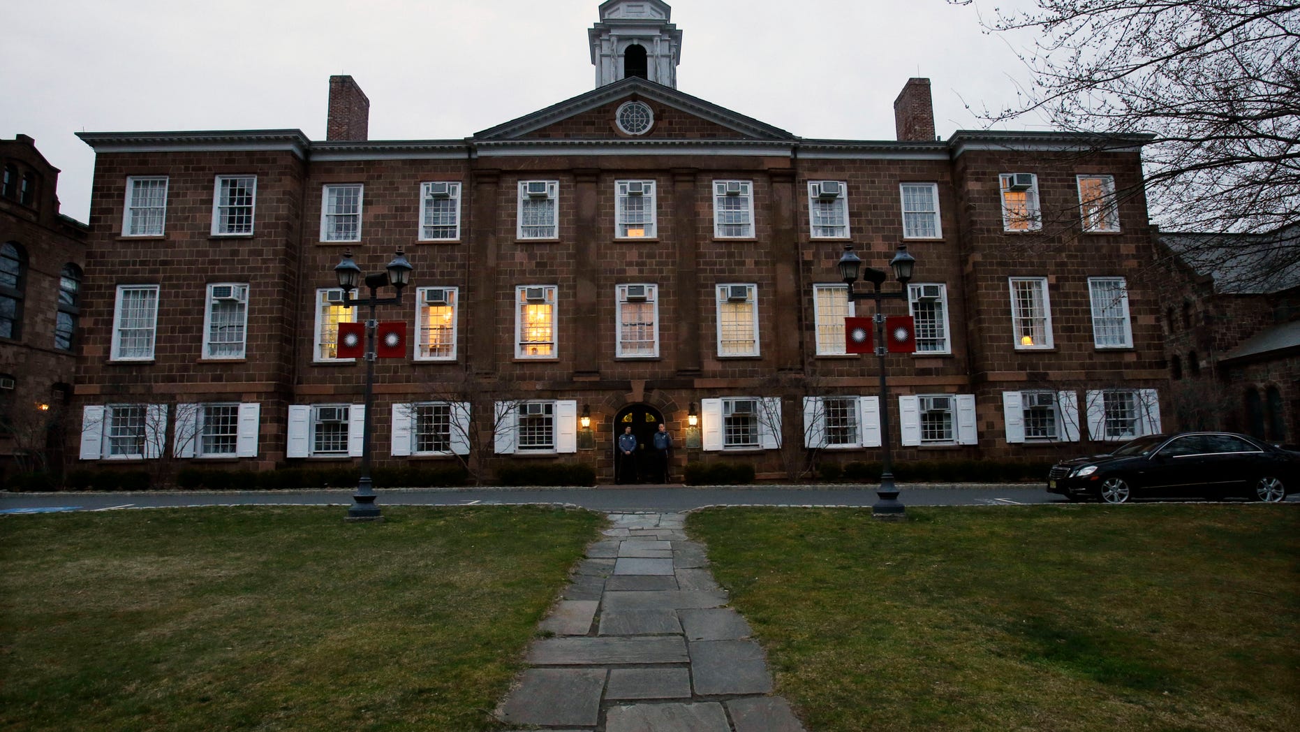 At dusk, lights remain on at Rutgers University's Old Queens building where President Robert Barchi was in a meeting Thursday, April 4, 2013, in New Brunswick, N.J., one day after Rutgers basketball head coach Mike Rice was fired. Rice was fired Wednesday after a videotape aired showing Rice using gay slurs, shoving and grabbing his players and throwing balls at them in practice. Scarlet Knights AD Tim Pernetti was given a copy of the video in late November by a disgruntled former employee, and he suspended Rice for three games, fined him $50,000 and made him undergo anger management classes for inappropriate behavior after investigating it. (AP Photo/Mel Evans)