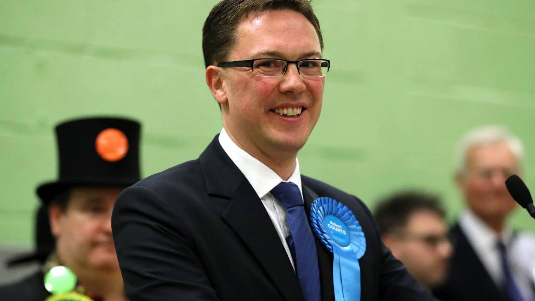 Conservative candidate Robert Courts makes a speech after winning the Witney by-election in Witney, England, Friday, Oct. 21, 2016. Britain's Conservative Party has retained the seat in Parliament vacated by former Prime Minister David Cameron, but with a sharply reduced majority. Conservative candidate Robert Courts won the rural English seat of Witney, taking 45 percent of votes cast _ down from the 60 percent Cameron achieved in the 2015 national election. The centrist Liberal Democrats surged past Labour into second place. Green candidate Larry Sanders _ brother of former Democrat presidential hopeful Bernie Sanders _ came fourth with 3.5 percent of the vote. (Chris Radburn/PA via AP)