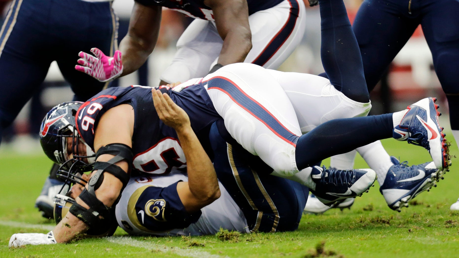 FILE - In this Oct. 13, 2013, file photo, Houston Texans defensive end J.J. Watt (99) takes down St. Louis Rams quarterback Sam Bradford during the first quarter of an NFL football game in Houston, Texas. The Indianapolis Colts have a major challenge on Sunday, Nov. 3, 2013: Keeping the Texans and Watt away from franchise quarterback Andrew Luck. (AP Photo/Eric Gay, File)