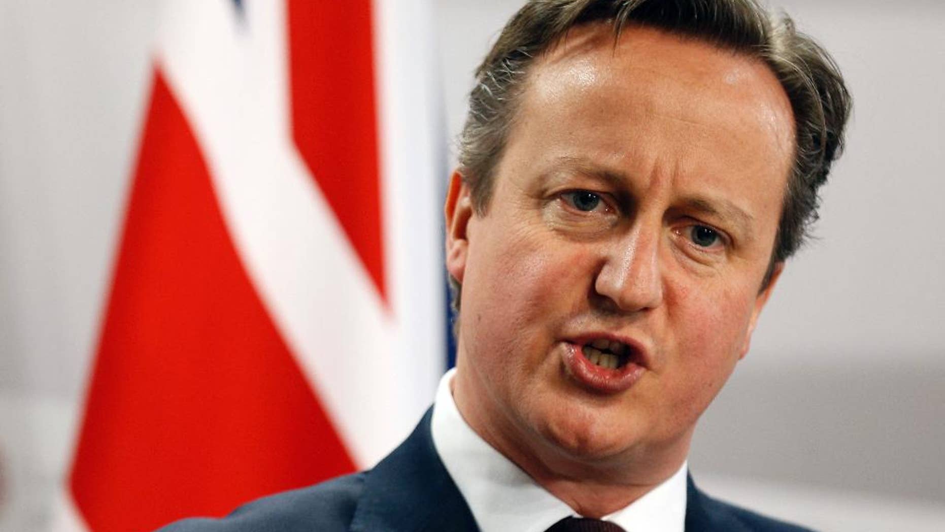 FILE - This is a Friday, May 22, 2015 file photo of British Prime Minister David Cameron as he speaks during a media conference at the conclusion of the Eastern Partnership summit in Riga, Latvia. Cameron declared Sunday July 19, 2015 that Britain needs to take a greater role in destroying the Islamic State group in Syria, his most direct signal to date that he will seek to expand his country's role in supporting the United States and its allies. (AP Photo/Mindaugas Kulbis, File)