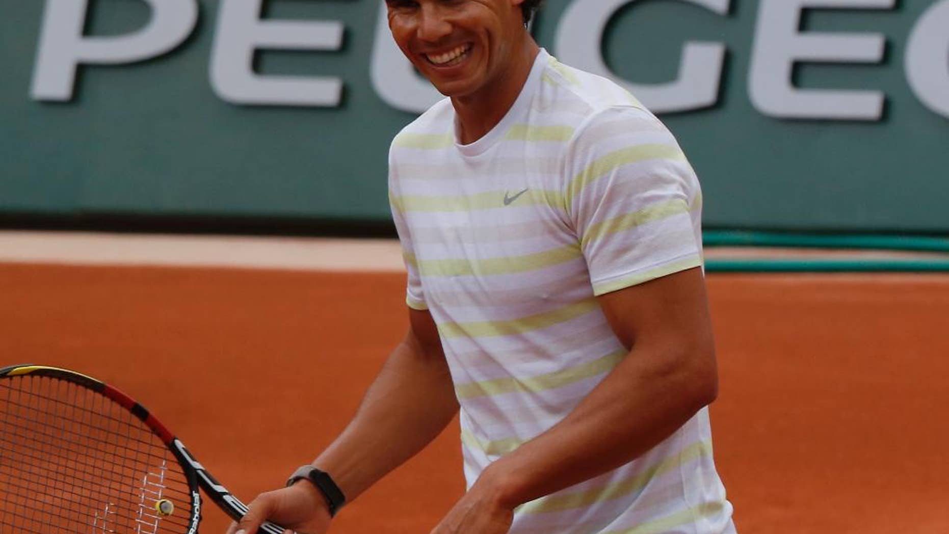 Defending champion Spain's Rafael Nadal smiles during a training session for the French Open tennis tournament, at the Roland Garros stadium in Paris, Friday, May 23, 2014. The French Open tennis championship will start Sunday. (AP Photo/Bertrand Combaldieu)