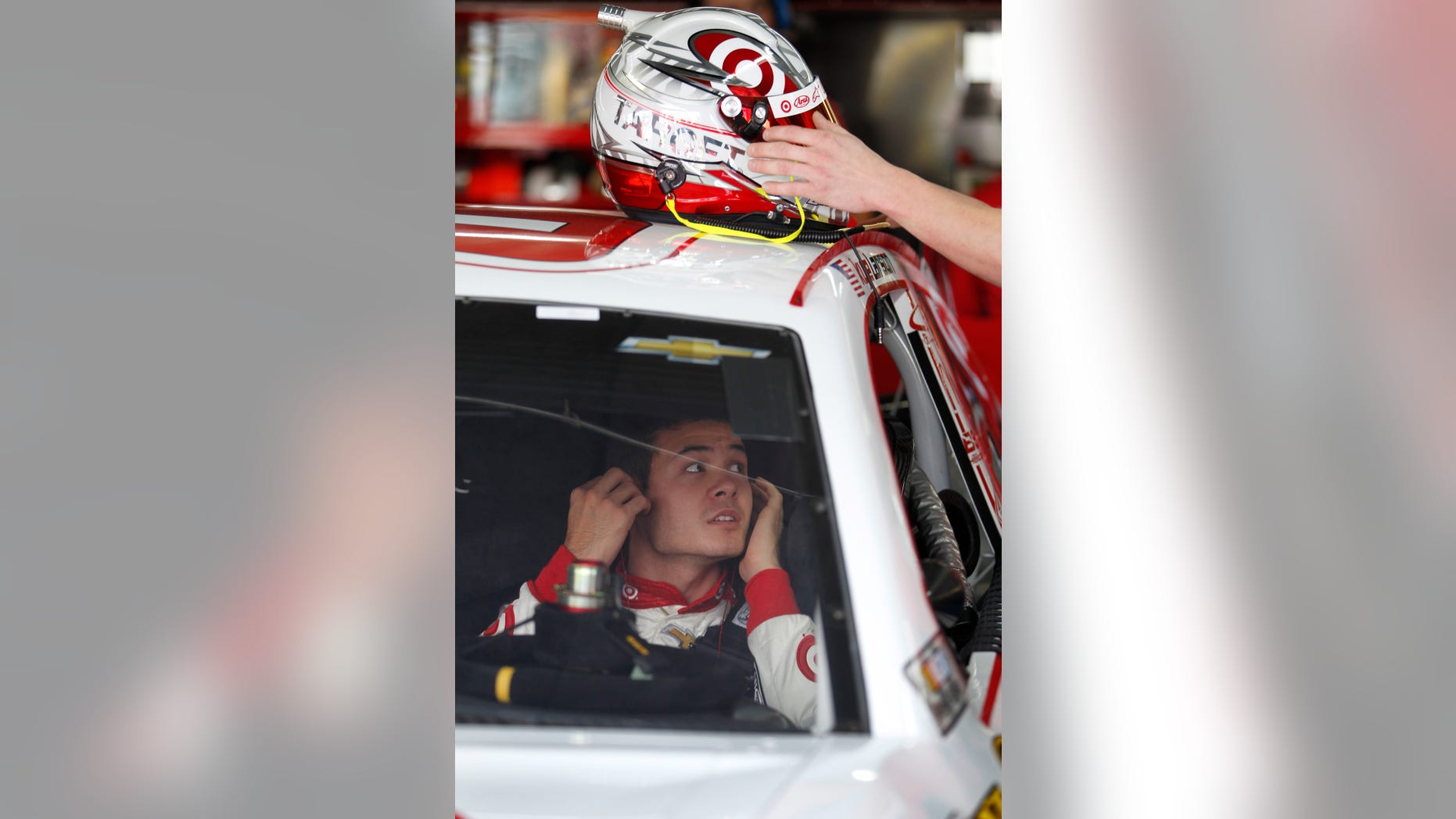 Kyle Larson waits in his car during practice for Saturday's NASCAR Sprint Cup series auto race at Charlotte Motor Speedway in Concord, N.C., Thursday, Oct. 10, 2013. (AP Photo/Terry Renna)