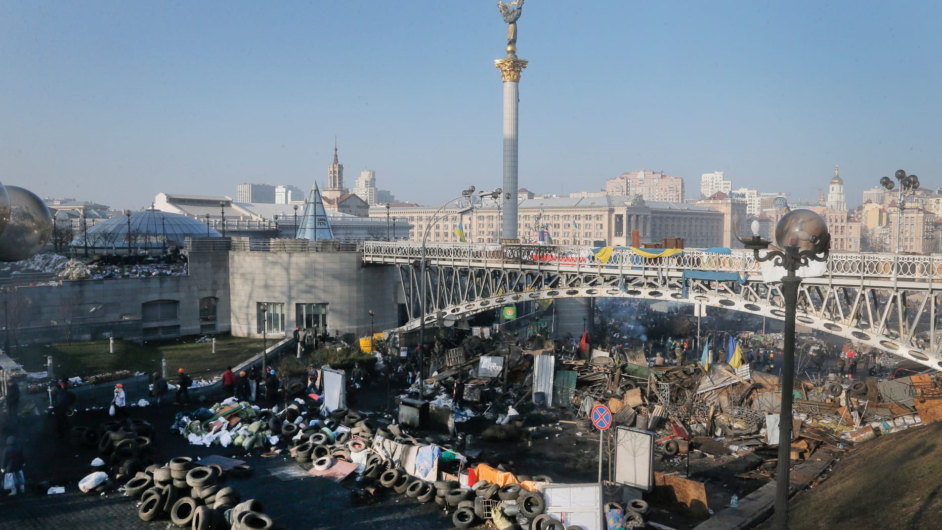 Opposition barricades are seen on the street to Independence Square, the epicenter of the country's current unrest, in Kiev, Ukraine, Friday, Feb. 21, 2014. Ukraine's president gave in to pressure from European diplomats and offered concessions Friday to defuse a crisis that has divided his country and left scores dead. Shots rang out near Kiev's protest camp and protesters fought among themselves about what to do next.(AP Photo/Efrem Lukatsky)