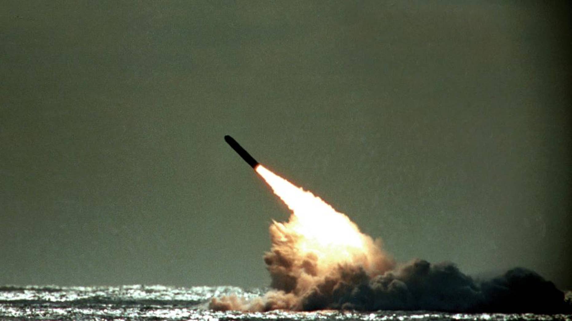 FILE - In this file photo dated Monday, Dec. 4, 1989, a Trident II missile launched by the U.S. Navy during a performance evaluation from the submerged submarine USS Tennessee in the Atlantic Ocean off the coast of Cape Canaveral in Titusville, Fla., USA. According to Britain's Sunday Times newspaper published Sunday Jan. 22, 2017, an unarmed nuclear test missile fired by a British submarine off the coast of Florida in 2016, misfired and the failure was allegedly covered up ahead of a debate in Parliament on the future of the Trident missile system. British Prime Minister Theresa May has refused to say whether she knew about the reported failure. (AP Photo/Phil Sandlin, FILE)