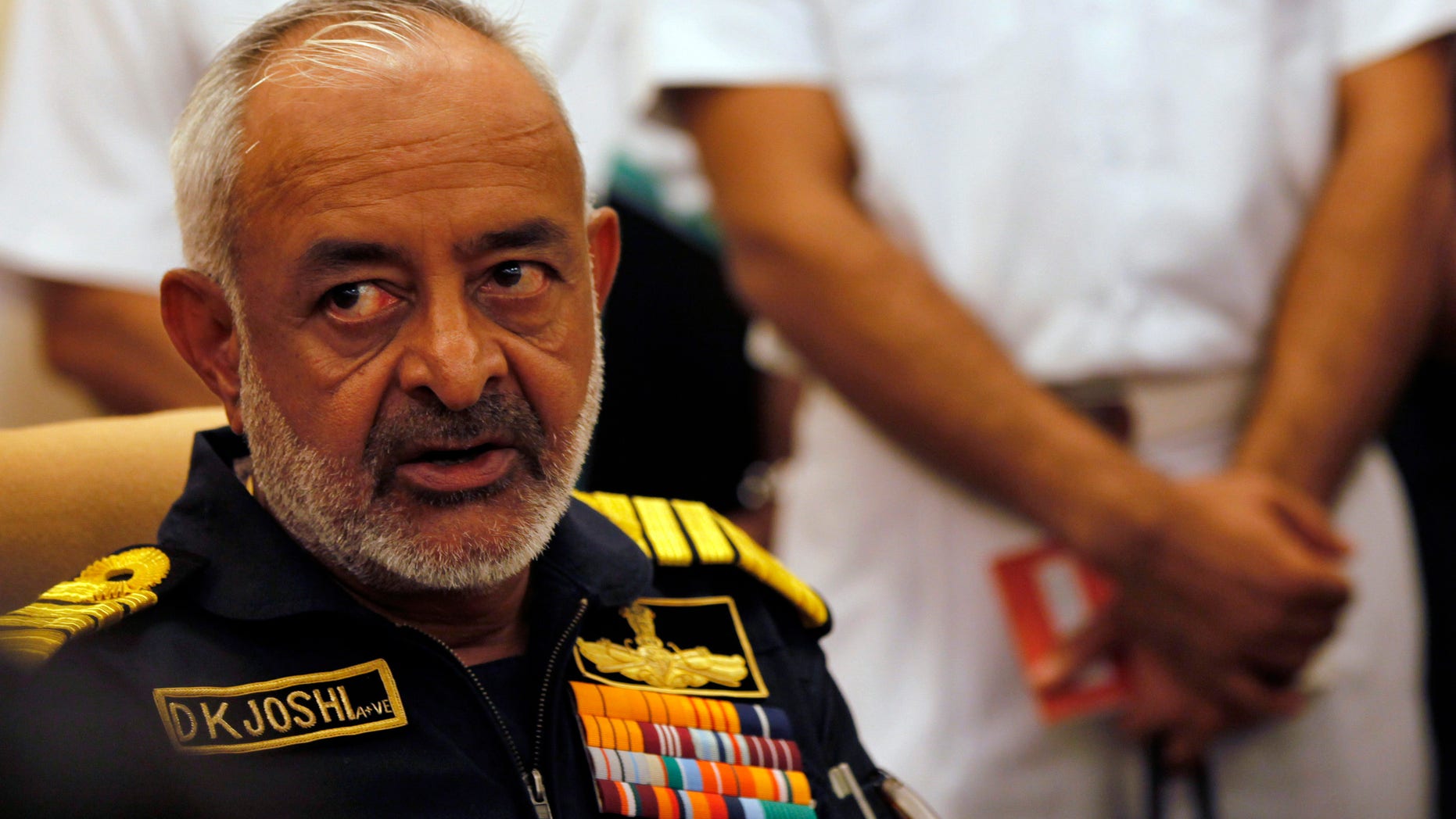 FILE - In this Wednesday, Aug. 14, 2013 file photo, India's navy chief Admiral D.K. Joshi watches at a press conference in Mumbai, India. Joshi resigned Wednesday hours after seven sailors were overcome with smoke on an Indian navy submarine, and two other sailors were missing in an accident off Mumbai’s coast. (AP Photo/Rajanish Kakade, File)